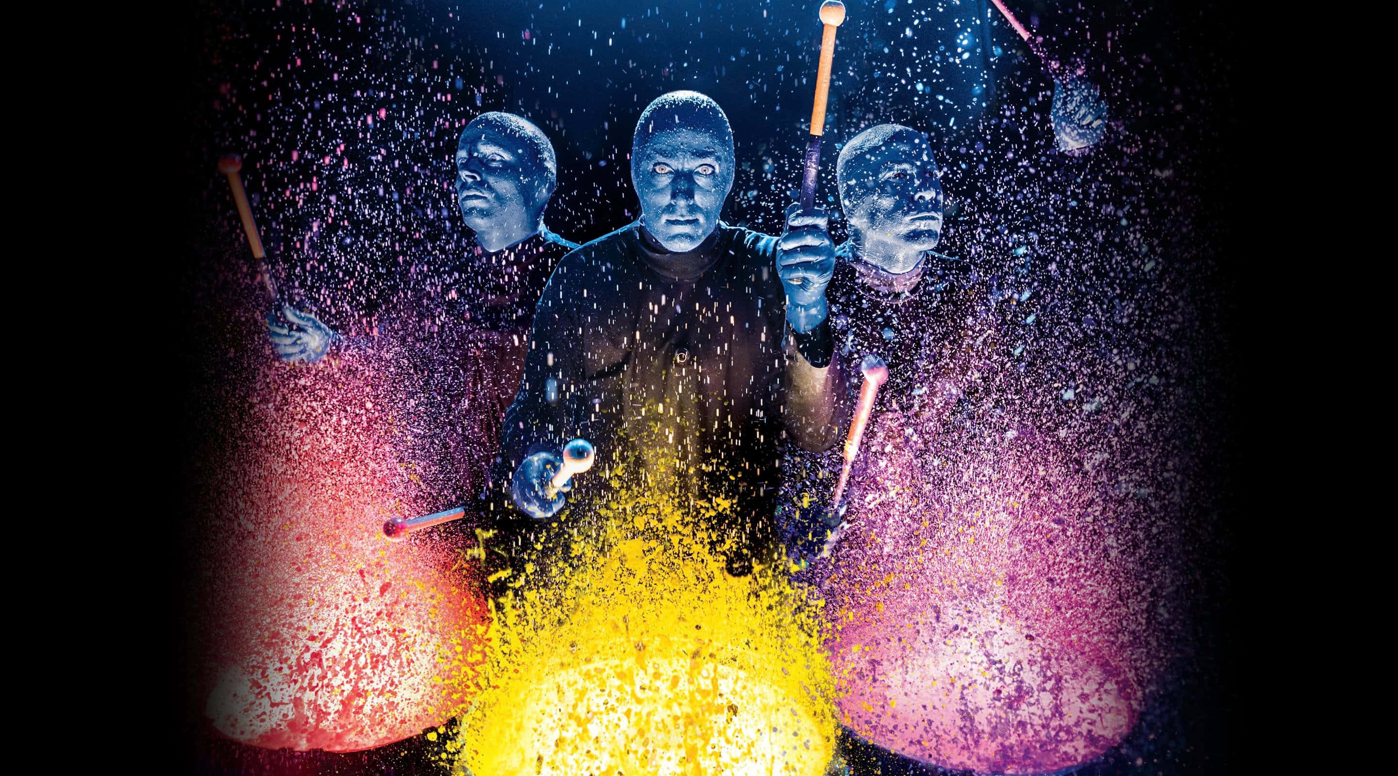 Blue Man Group, blue-faced drummers, vibrant colored sparks, 2K Desktop Wallpaper