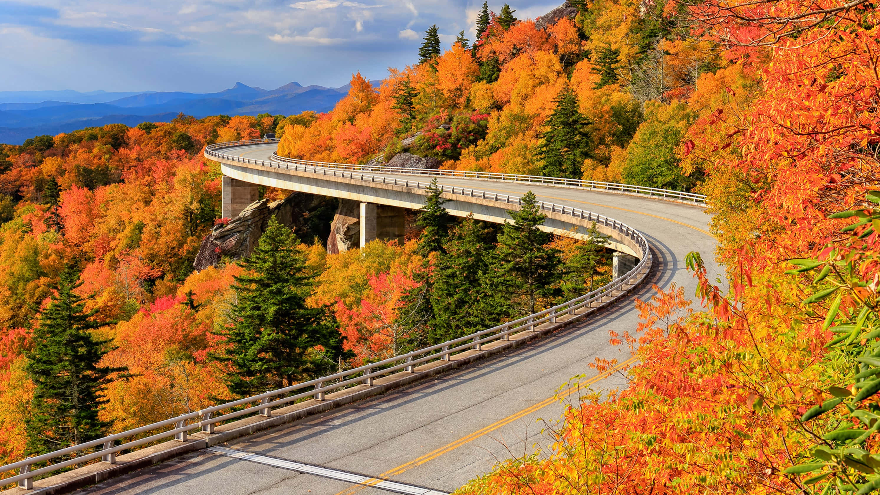 Blue Ridge Mountains, winding mountain road, vibrant autumn foliage, 2K Desktop Wallpaper