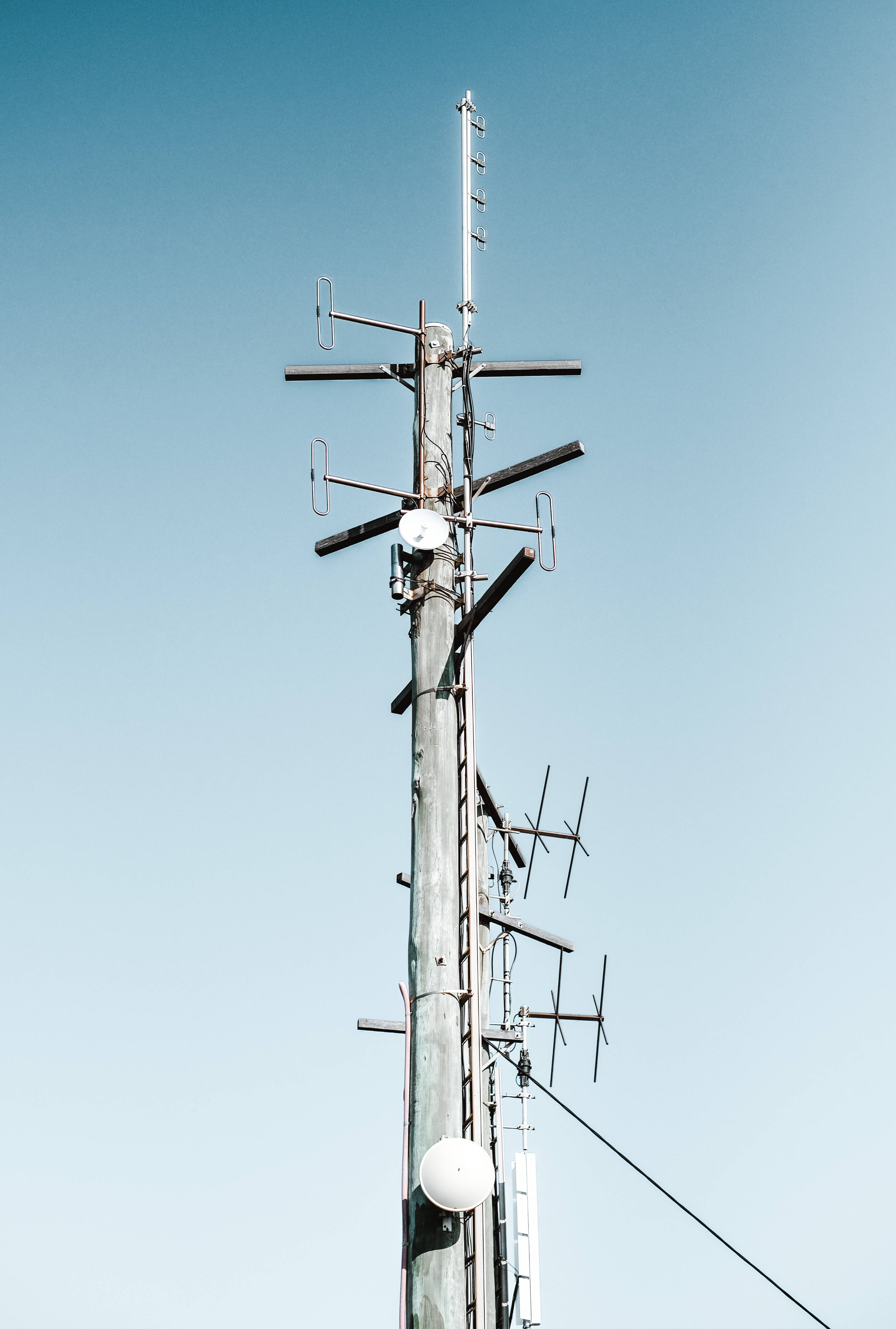 Blue Post Aesthetic Phone, tall wooden utility pole, multiple antennas and dishes, 5K Phone Wallpaper