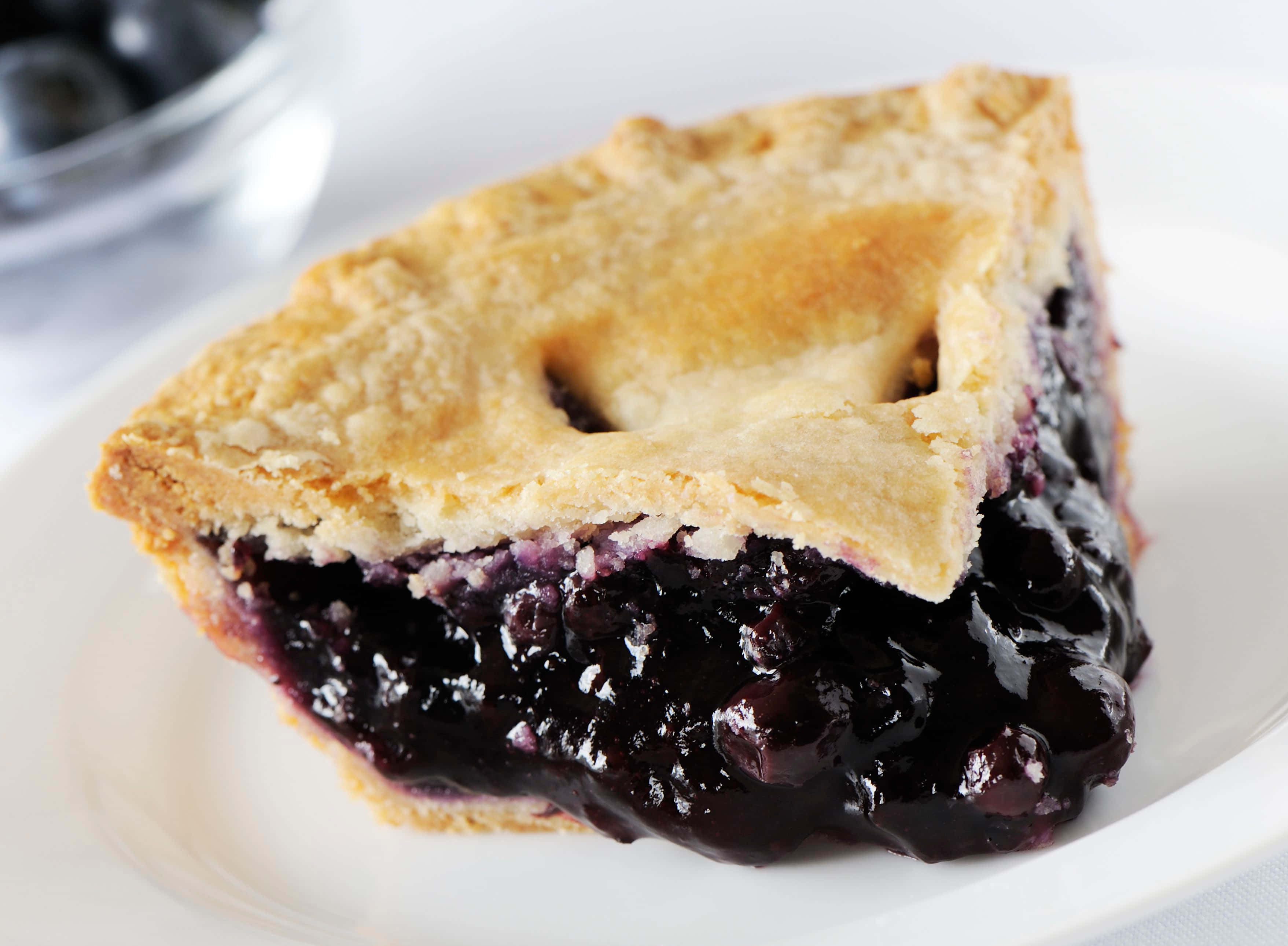 blueberry pie, golden flaky slice, juicy dark filling, 2K Desktop Wallpaper