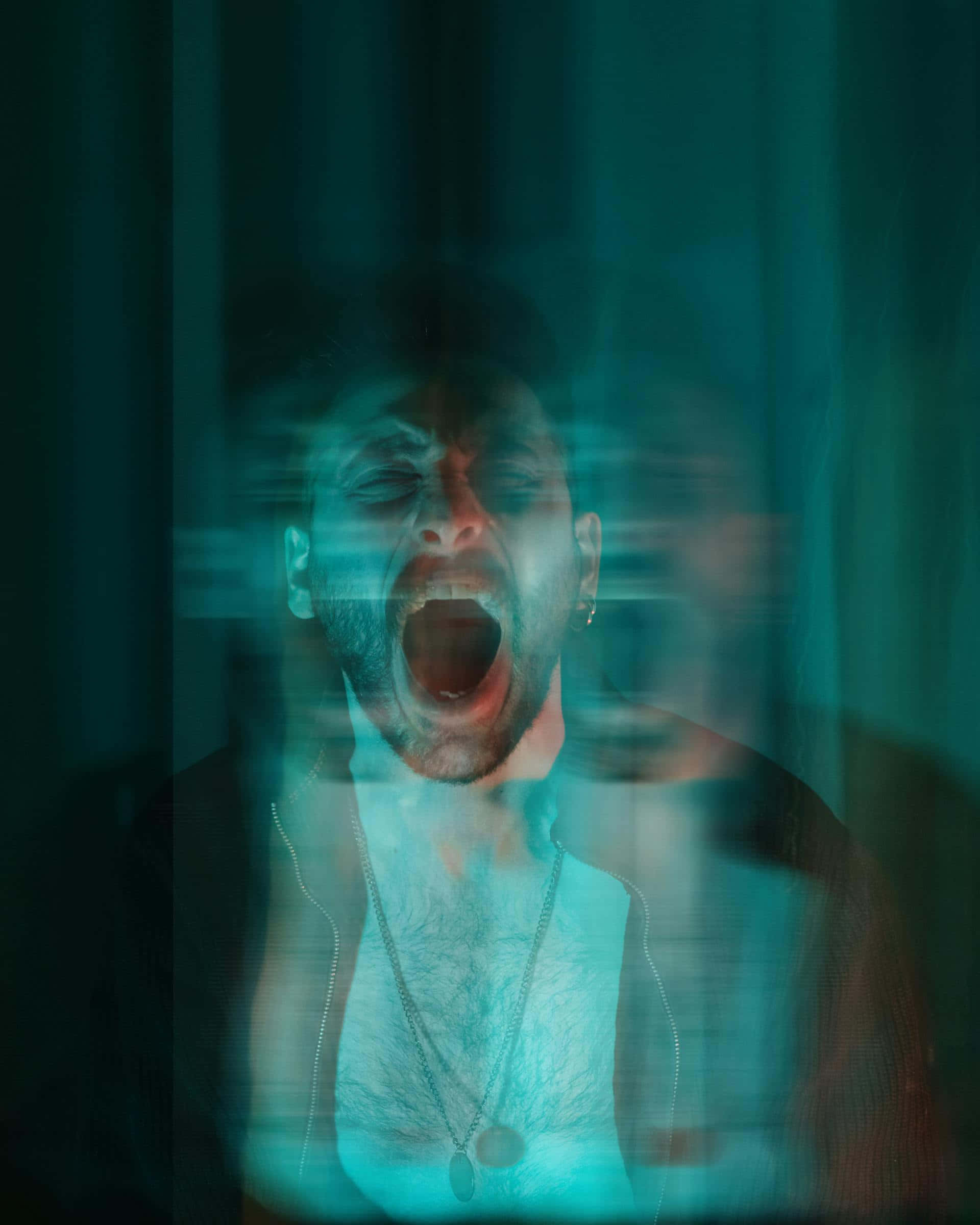 man, yawns widely, dim teal-lit room, Full HD Phone Wallpaper