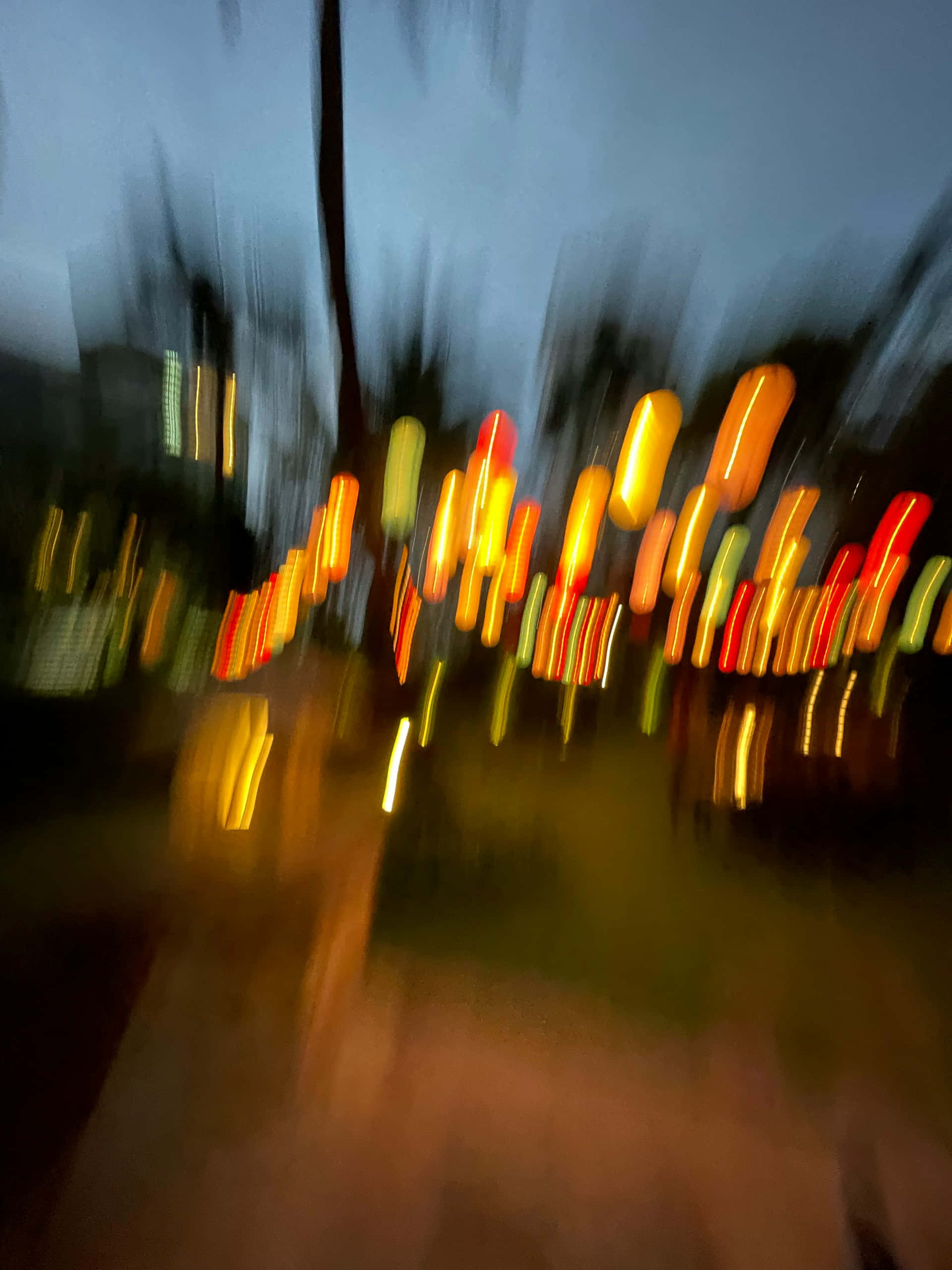 abstract urban lights blur, motion-blurred night scene, streaks of warm orange red and yellow lights, 2K Phone Wallpaper