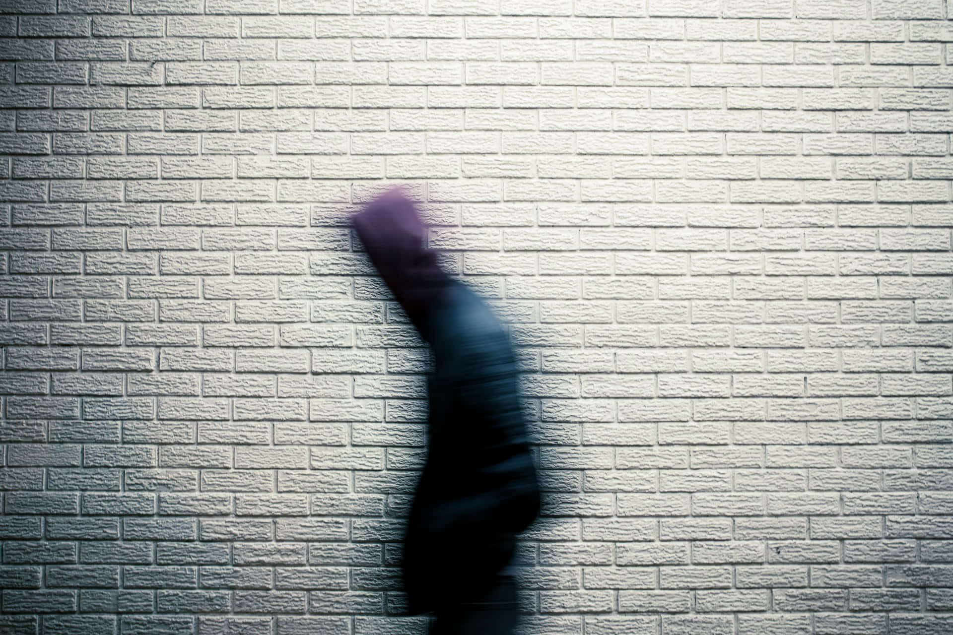 blurry figure, dark clothing, textured white brick wall, Full HD Desktop Wallpaper