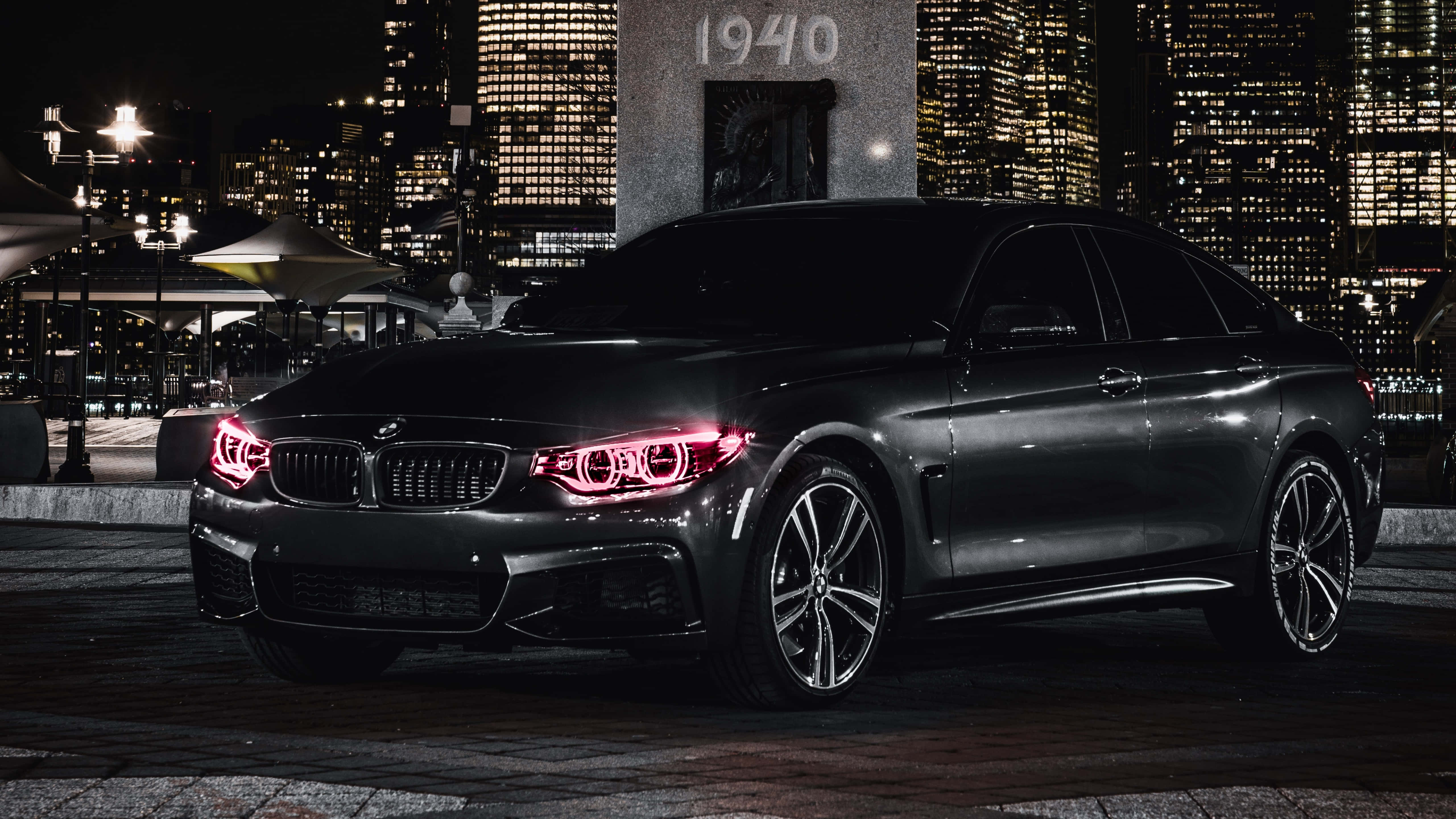 BMW 440i, sleek black, glowing red headlights, 5K Desktop Wallpaper