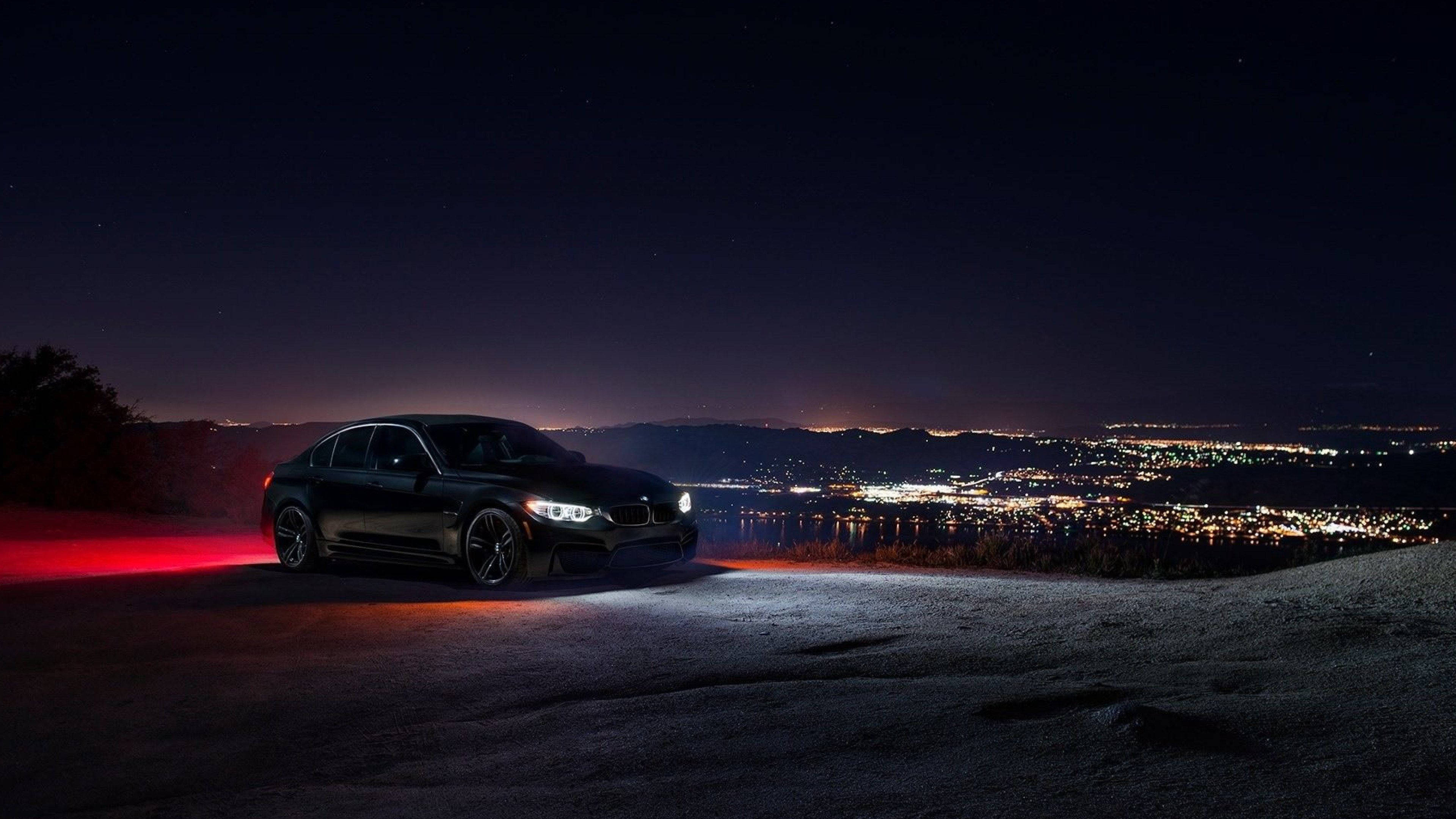 BMW, sleek black sports car, red lights, 4K Desktop Wallpaper