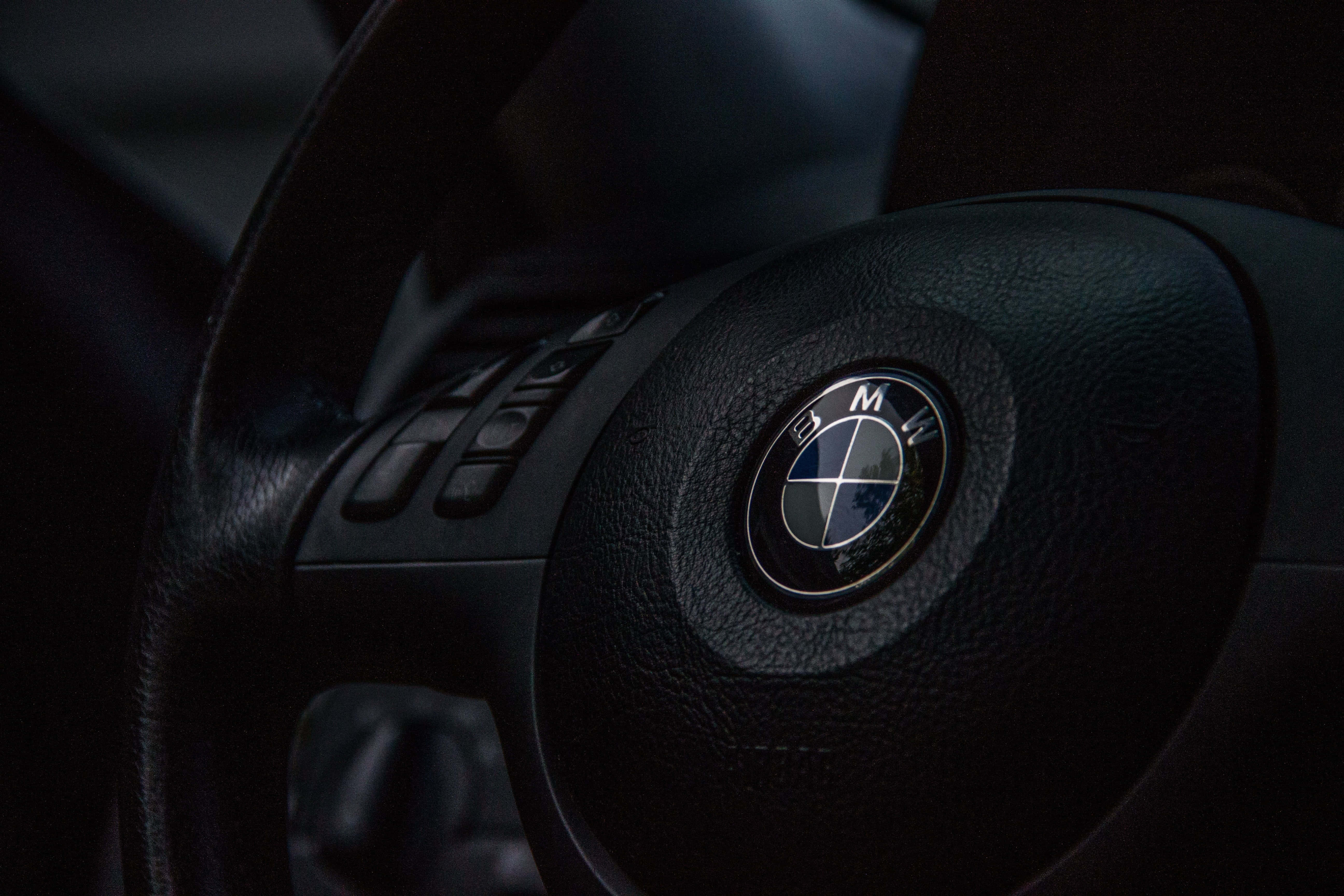 BMW logo, black BMW steering wheel, textured leather, 5K Desktop Wallpaper