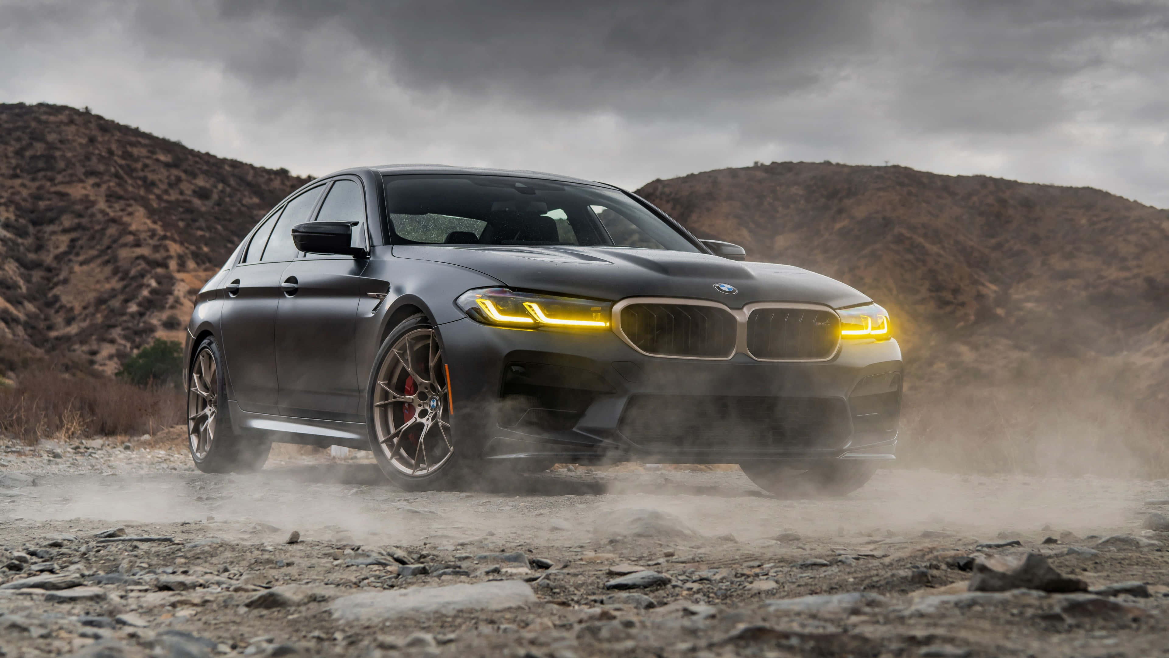 BMW M5, matte black, glowing yellow headlights, 4K Desktop Wallpaper