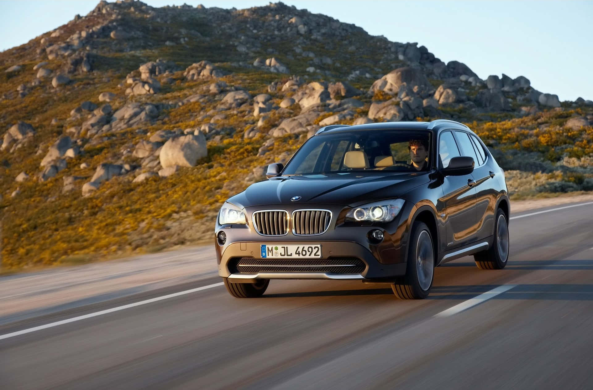BMW X1, sleek black, winding mountain road, Full HD Desktop Wallpaper