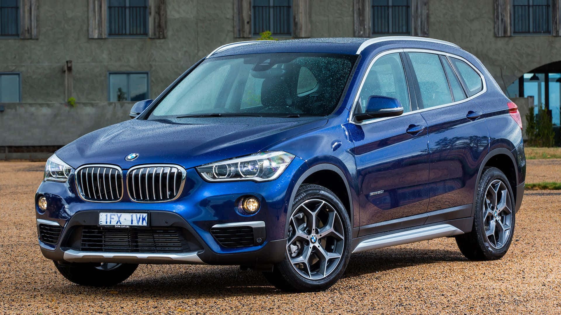 BMW X1, glossy blue, gravel, Full HD Desktop Wallpaper