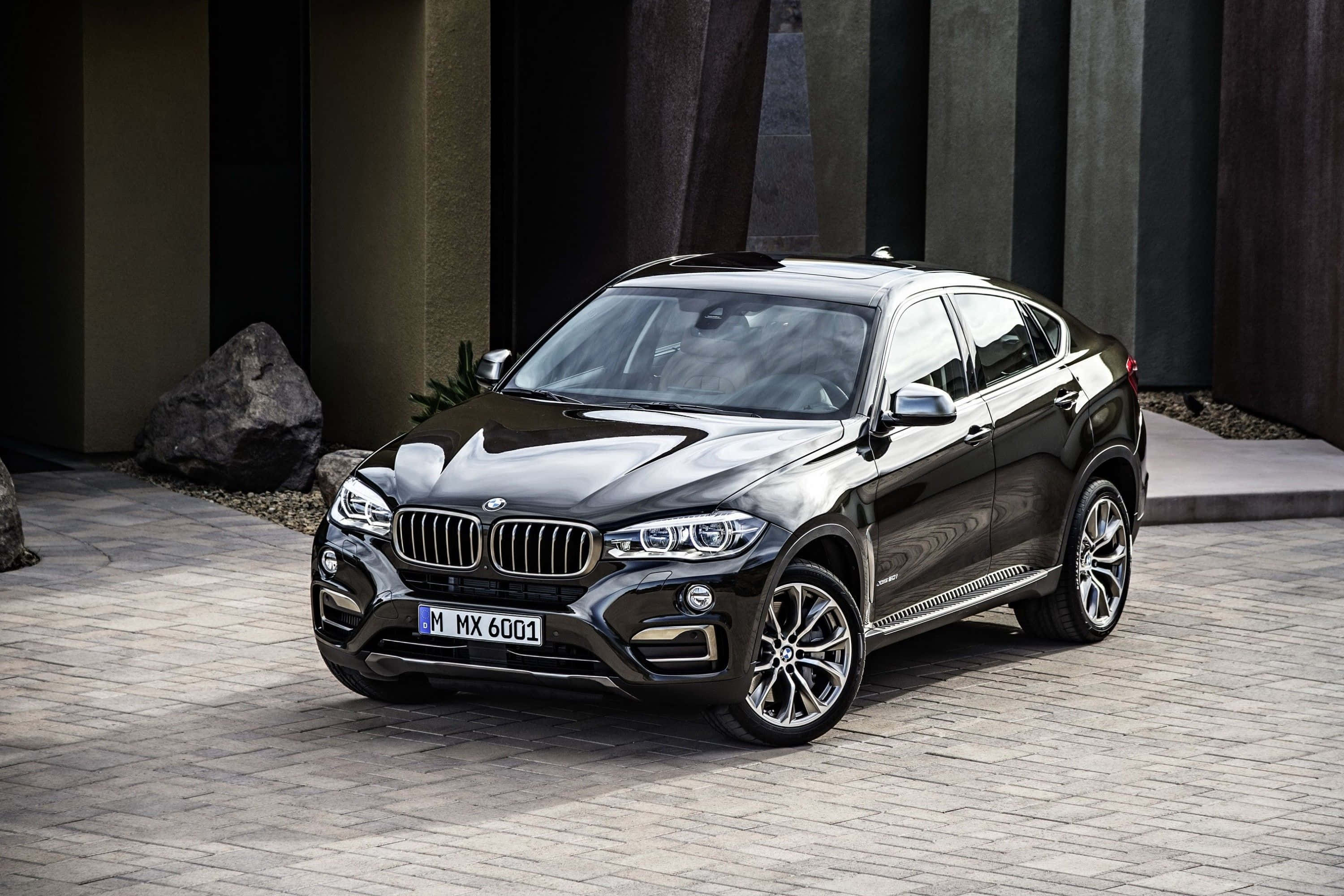 BMW X6 M, sleek black, stone-paved driveway, 2K Desktop Wallpaper