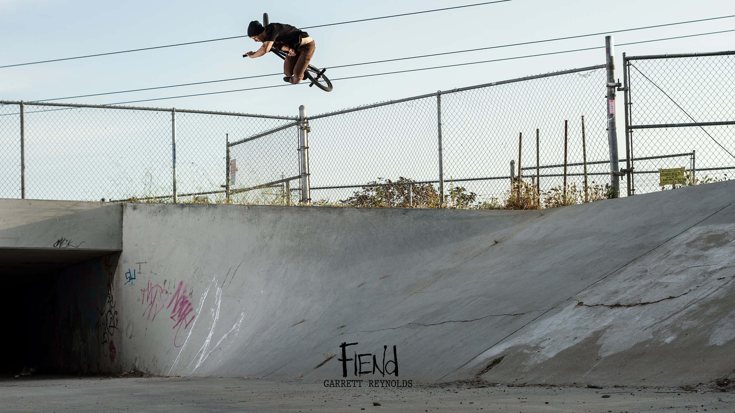 BMX, graffiti-tagged concrete ramp, clear sky, 2K Desktop Wallpaper
