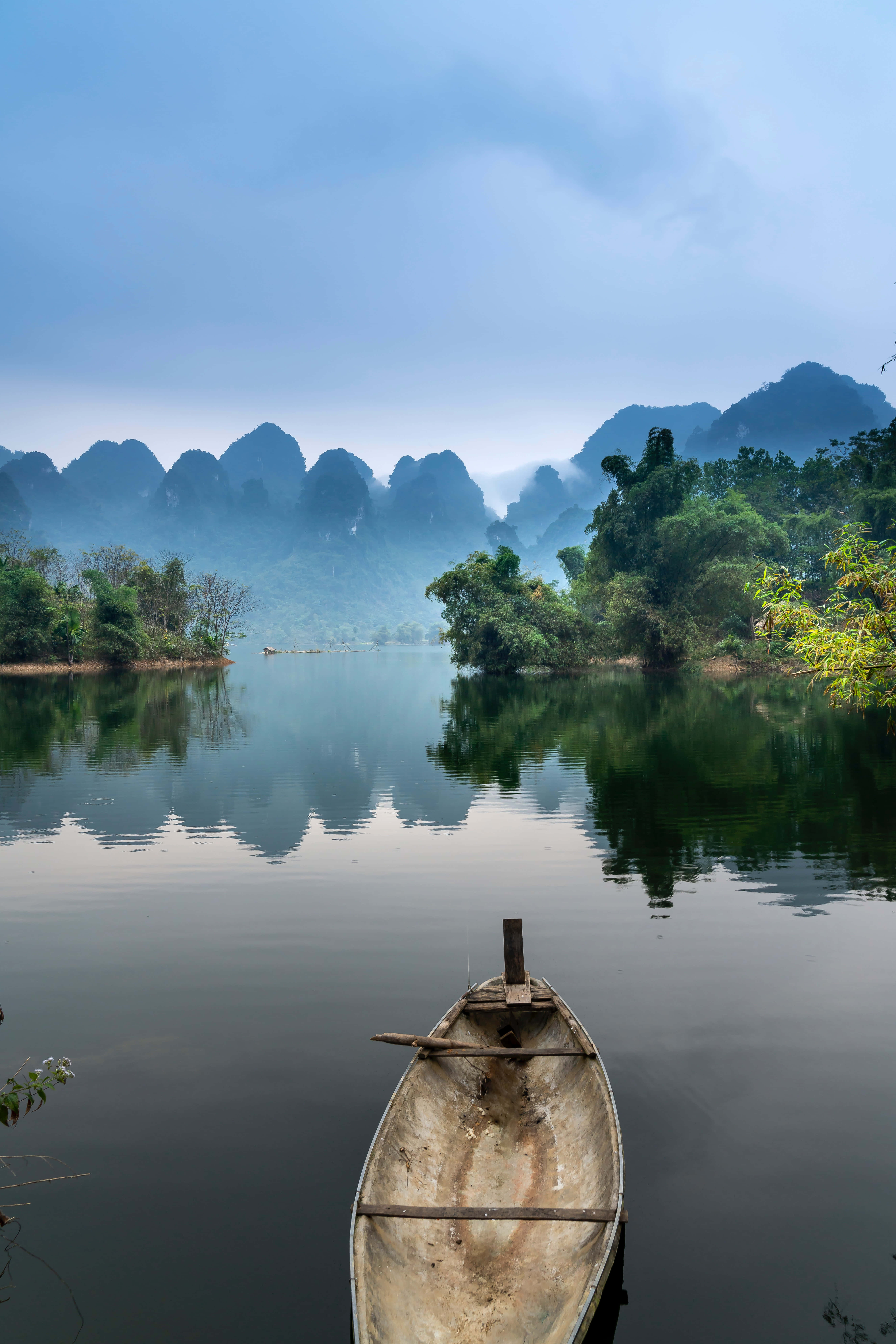 wooden boat, glassy river, misty karst mountains, 8K Phone Wallpaper