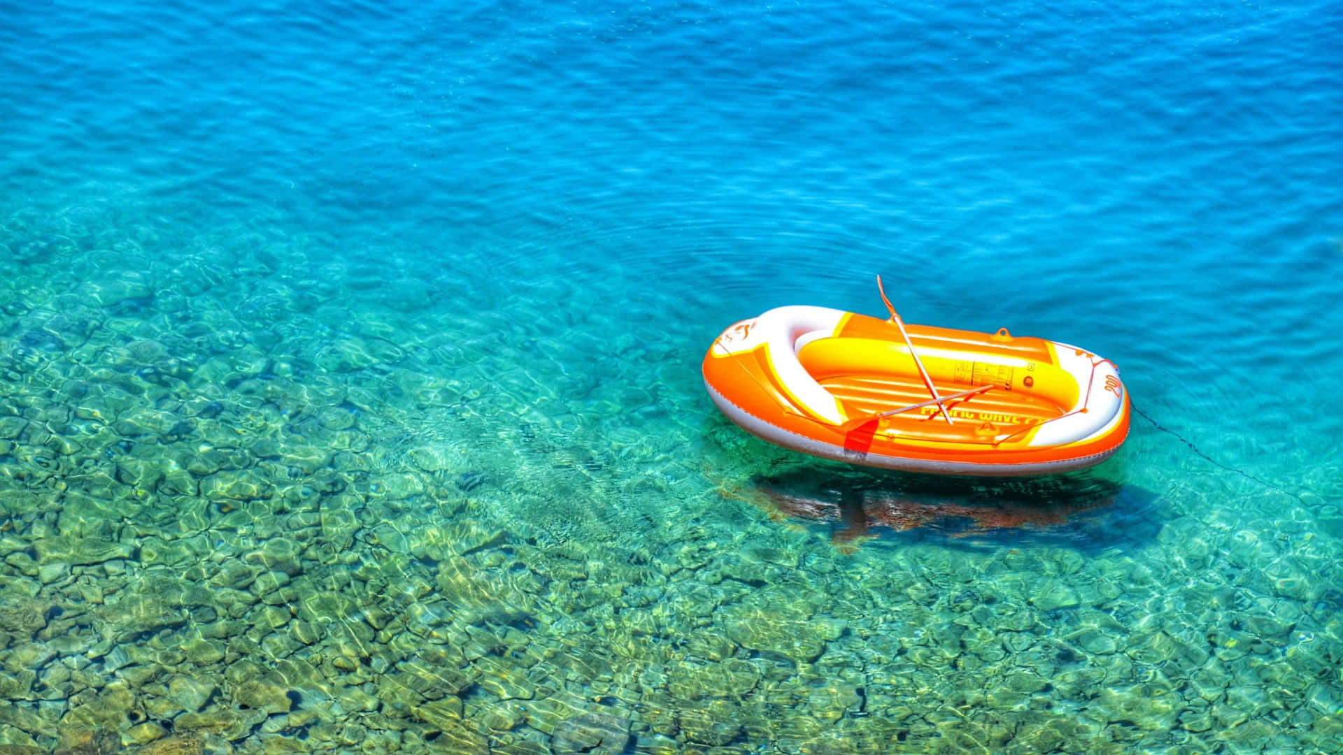 bright orange inflatable raft, crystal clear turquoise water, rocky seabed, Full HD Desktop Wallpaper