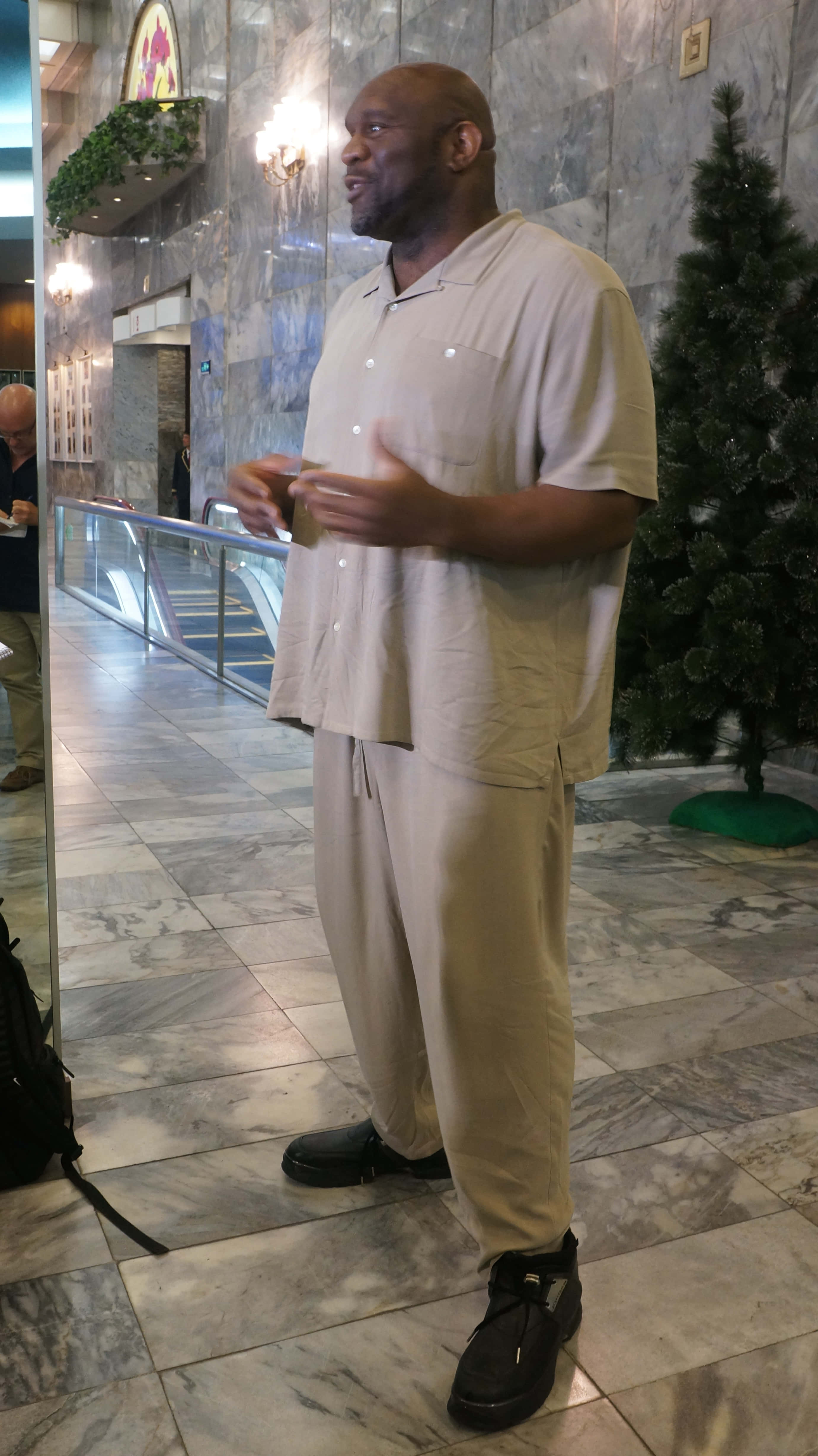 Bob Sapp, beige loungewear, marble-floored lobby, 4K Phone Wallpaper