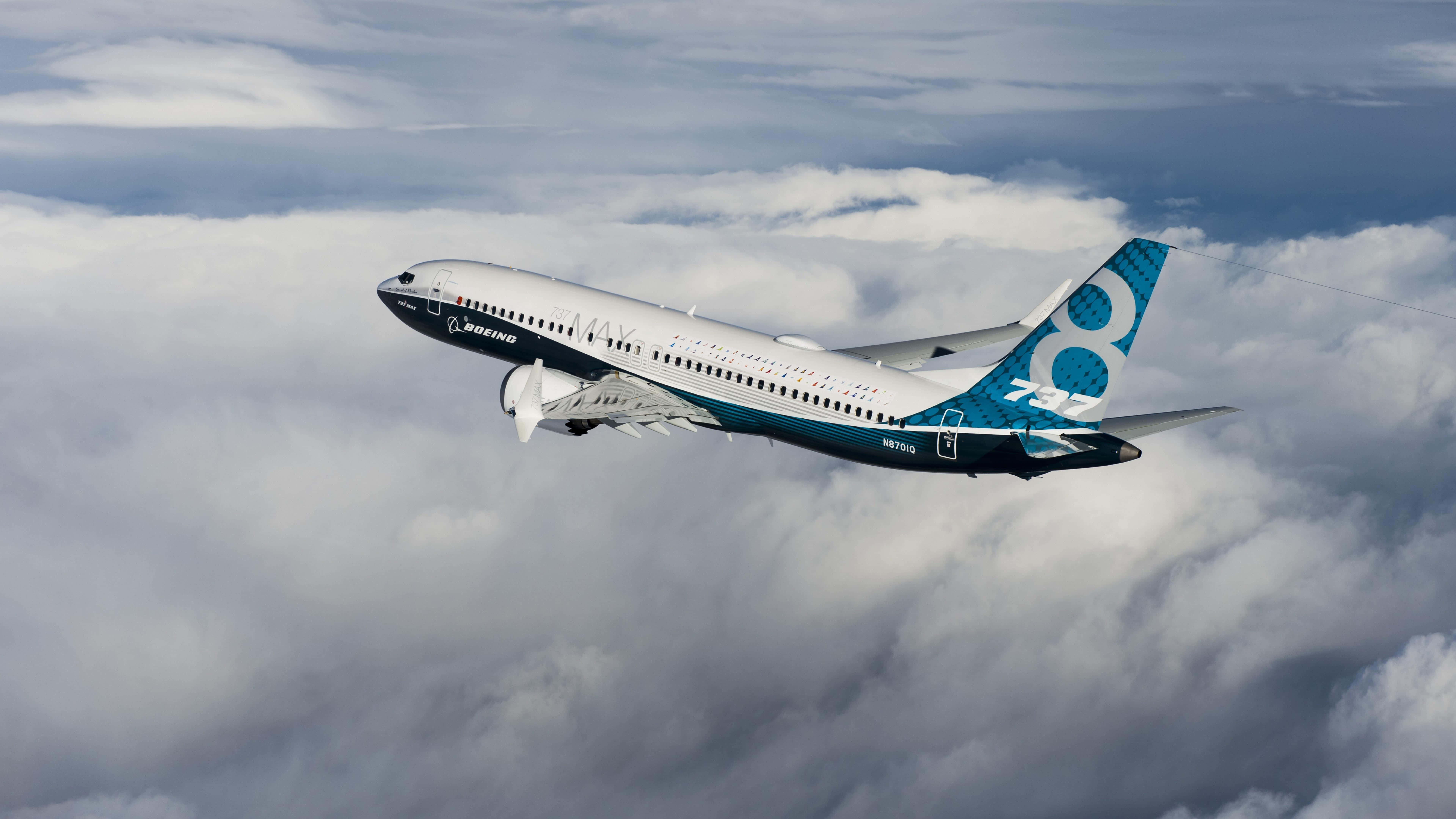 Boeing 737, fluffy white clouds, soft blue sky, 8K Desktop Wallpaper