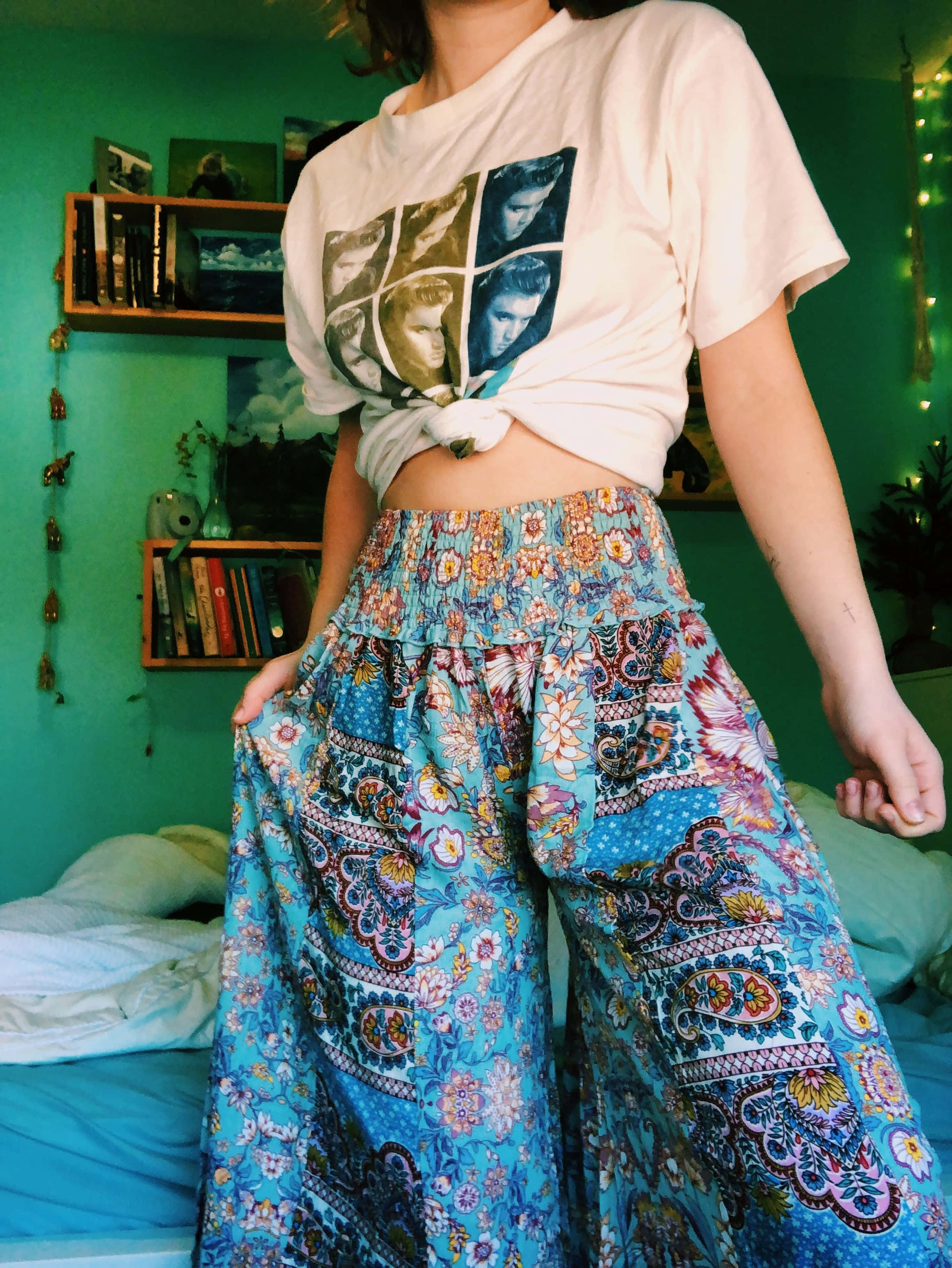 cropped graphic tee, vibrant blue patterned pants, teal-walled bedroom, 2K Phone Wallpaper