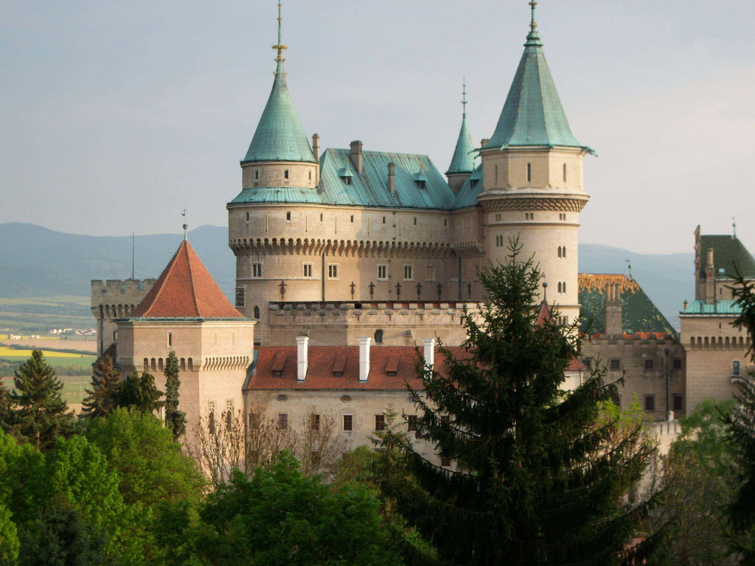 Bojnice Castle, teal conical roofs, stone towers, 2K Desktop Wallpaper