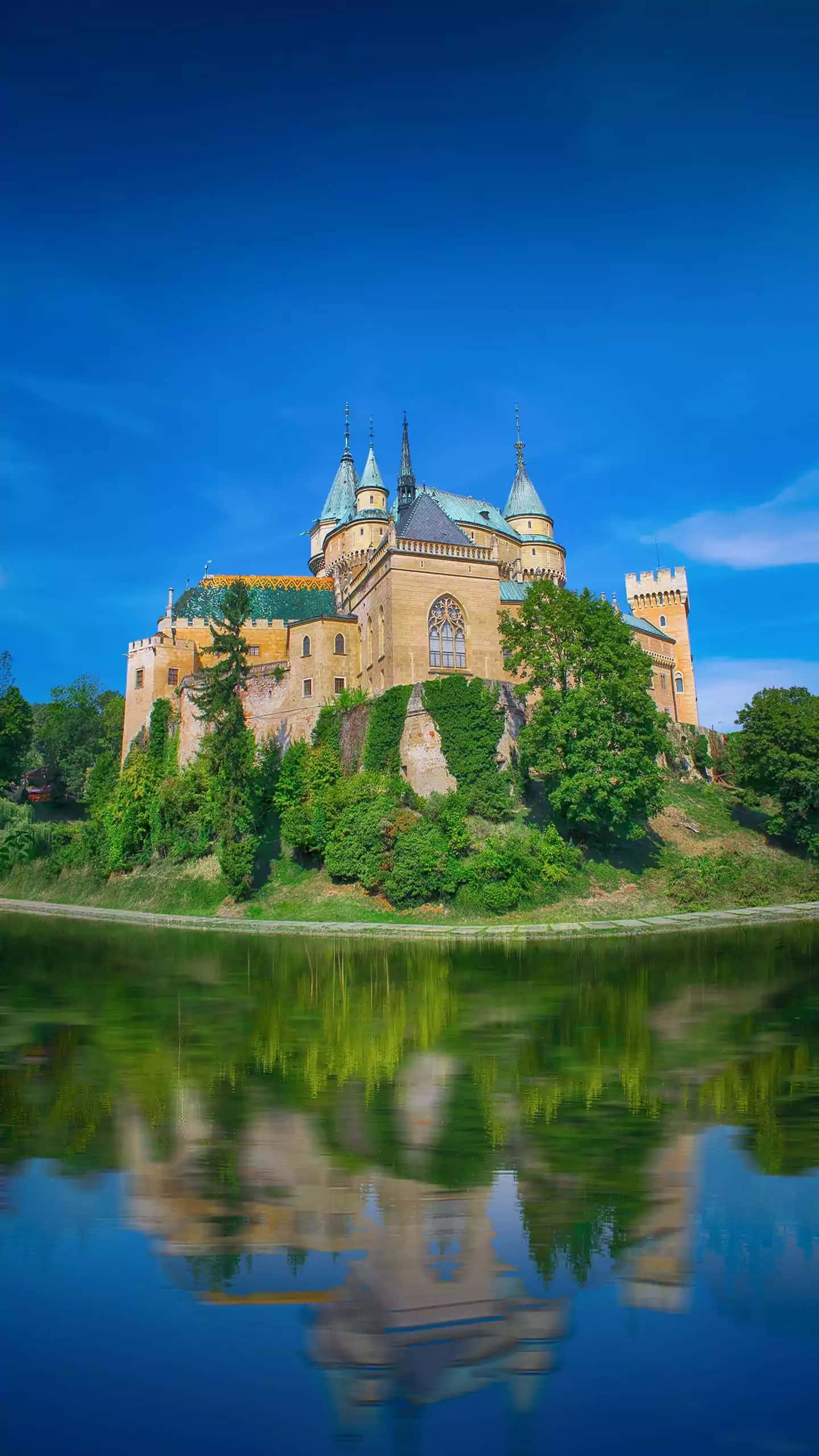 Bojnice Castle, blue spires, golden stone towers, 2K Phone Wallpaper