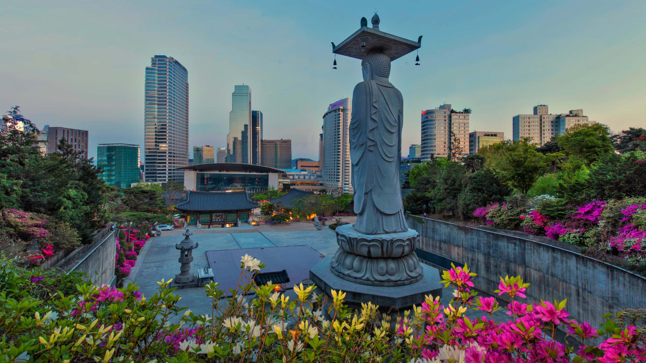 Bongeunsa Temple, stone Buddha statue, vibrant pink flowers, 2K Desktop Wallpaper
