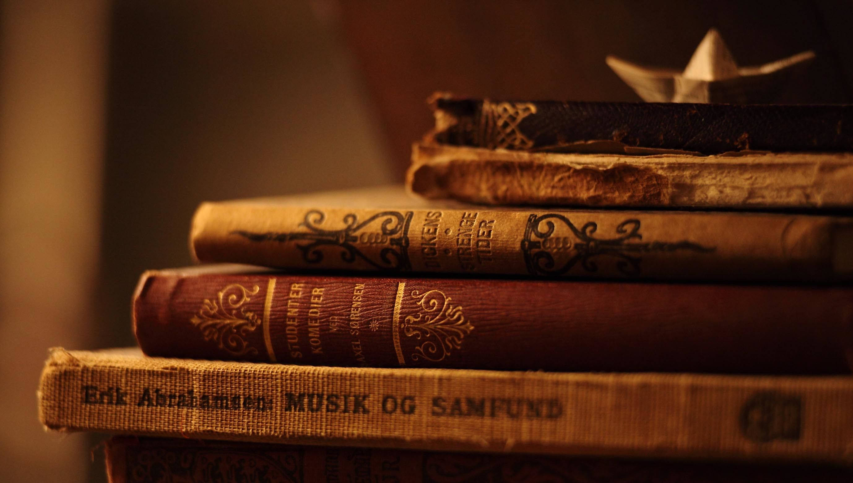 vintage aesthetic, stacked antique novels, ornate spines, 2K Desktop Wallpaper