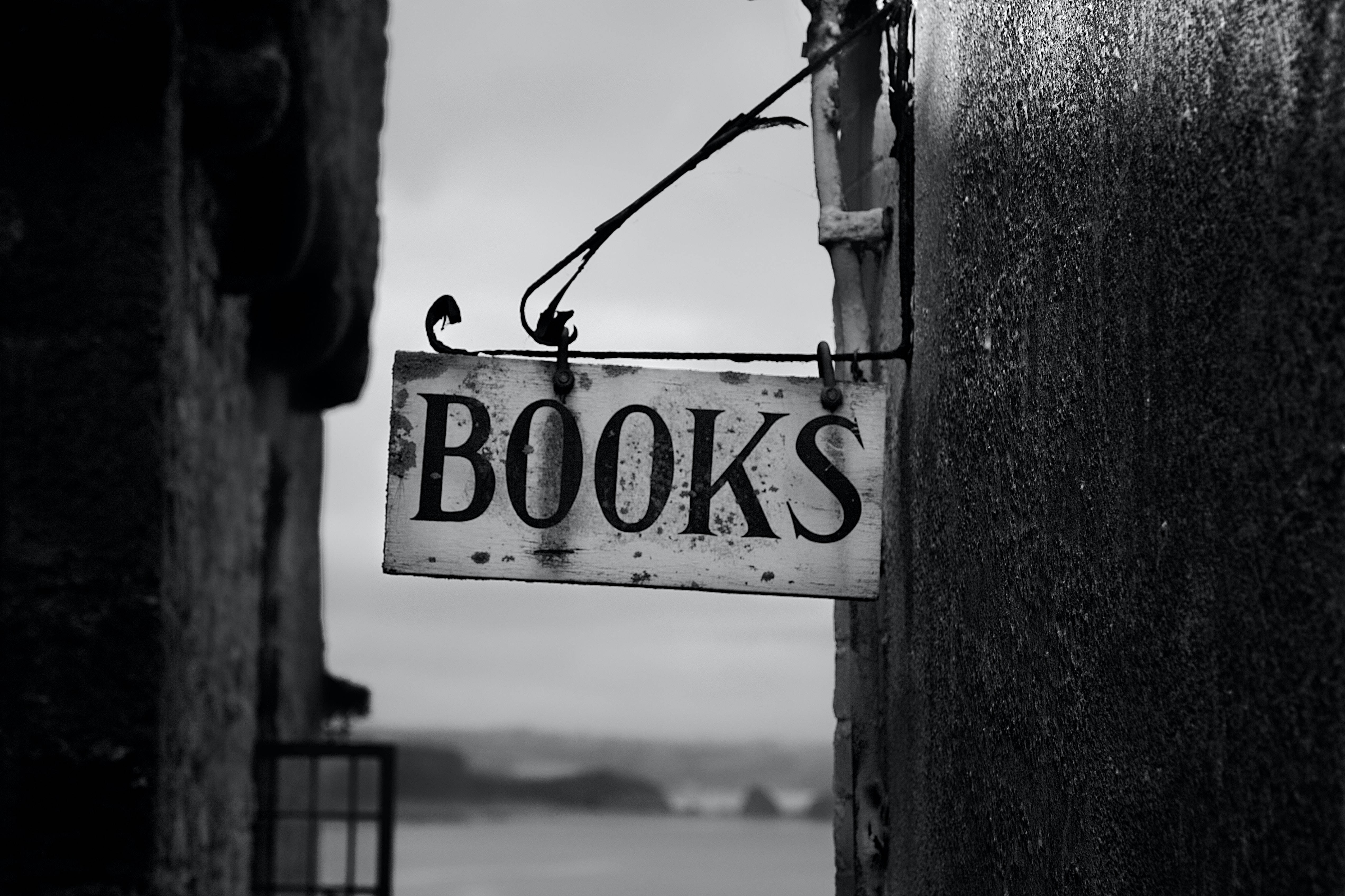 BOOKS, weathered black and white sign, stone walls, 4K Desktop Wallpaper