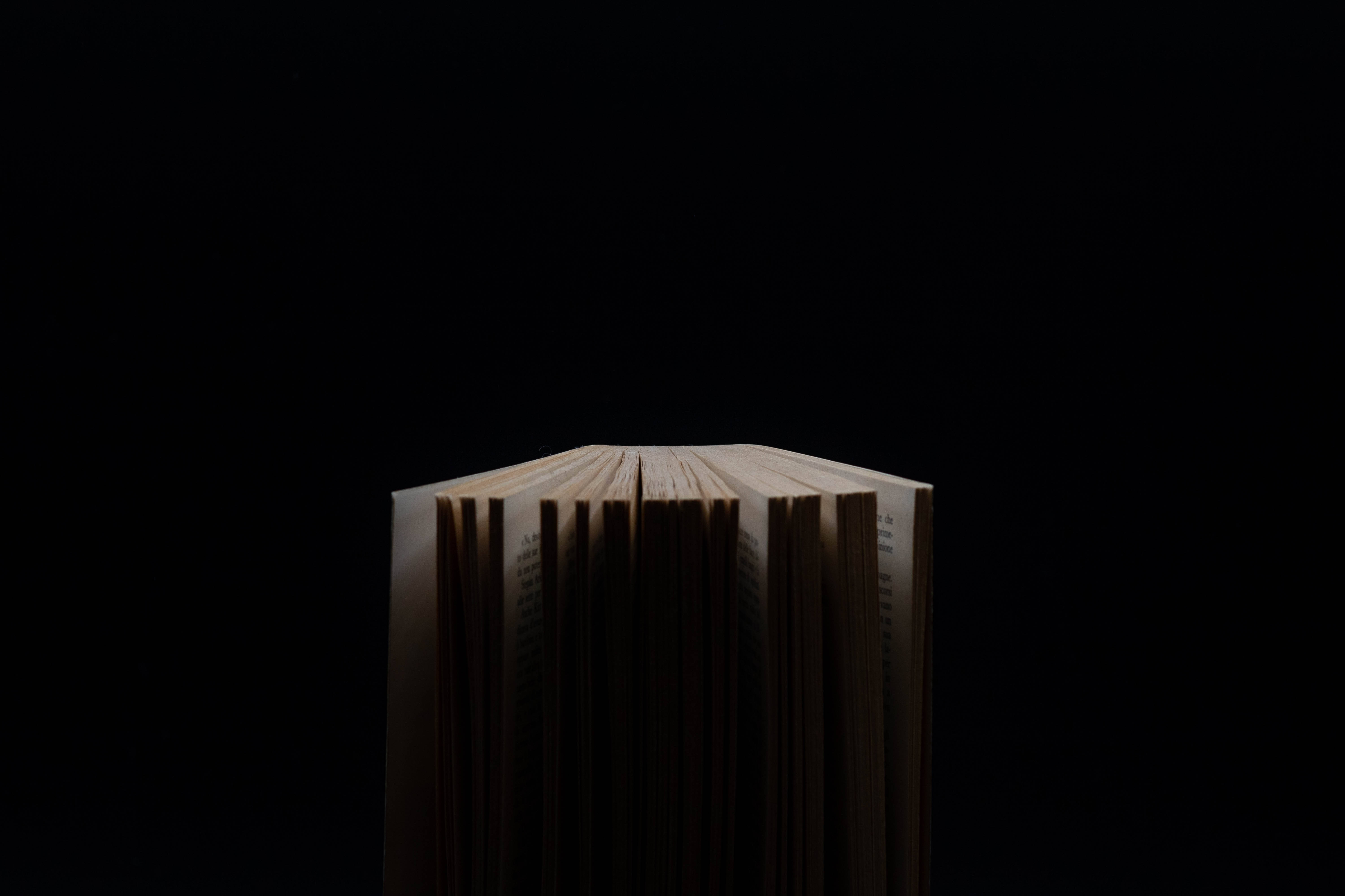 dark book fanned pages, open book, pitch black background, 5K Desktop Wallpaper