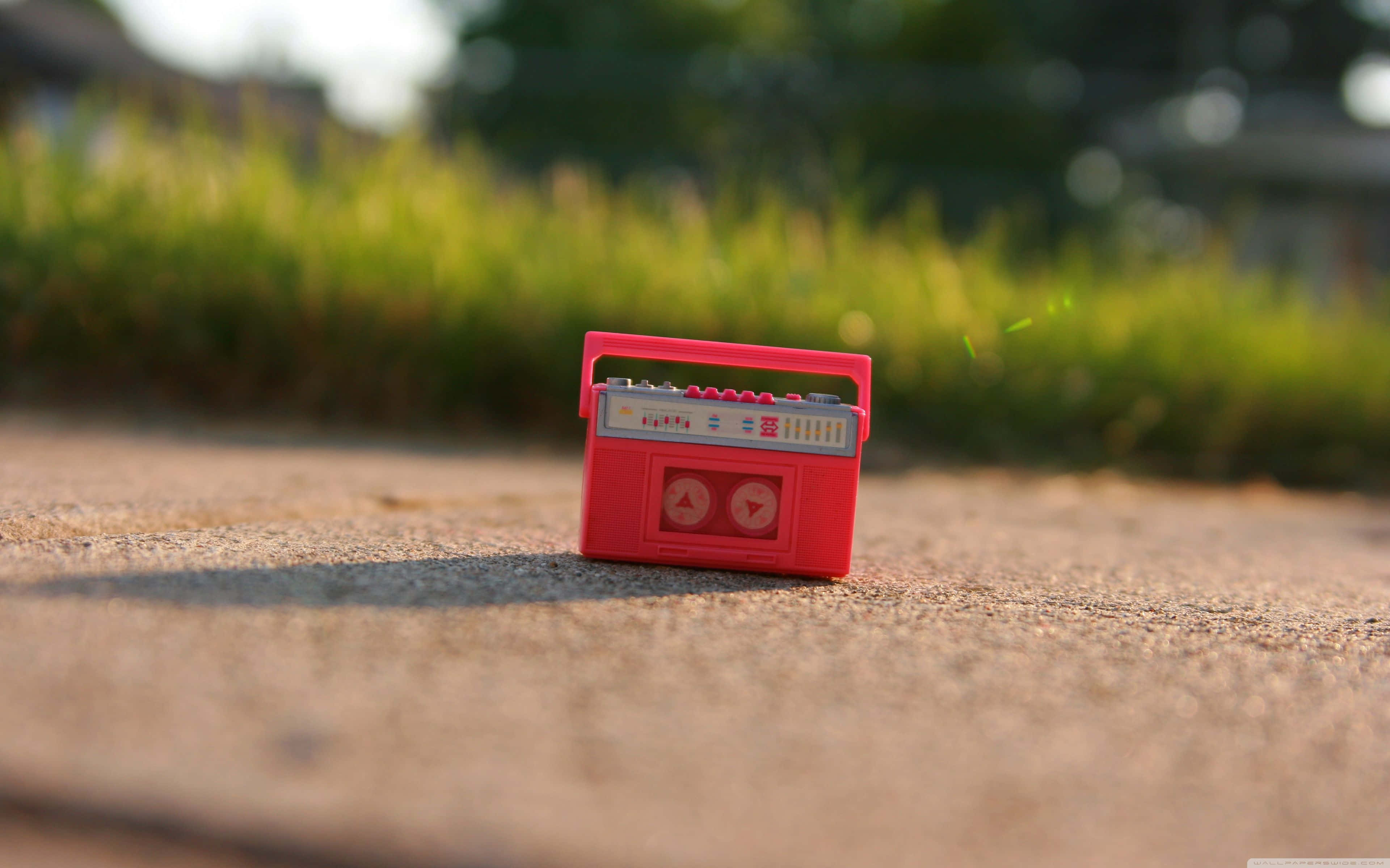 red cassette tape, toy boombox, sunlit concrete path, 4K Desktop Wallpaper
