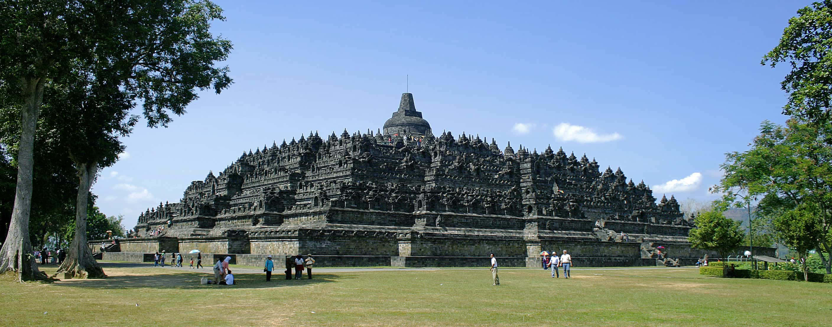Borobudur Temple, clear blue sky, lush green trees, 2K Desktop Wallpaper