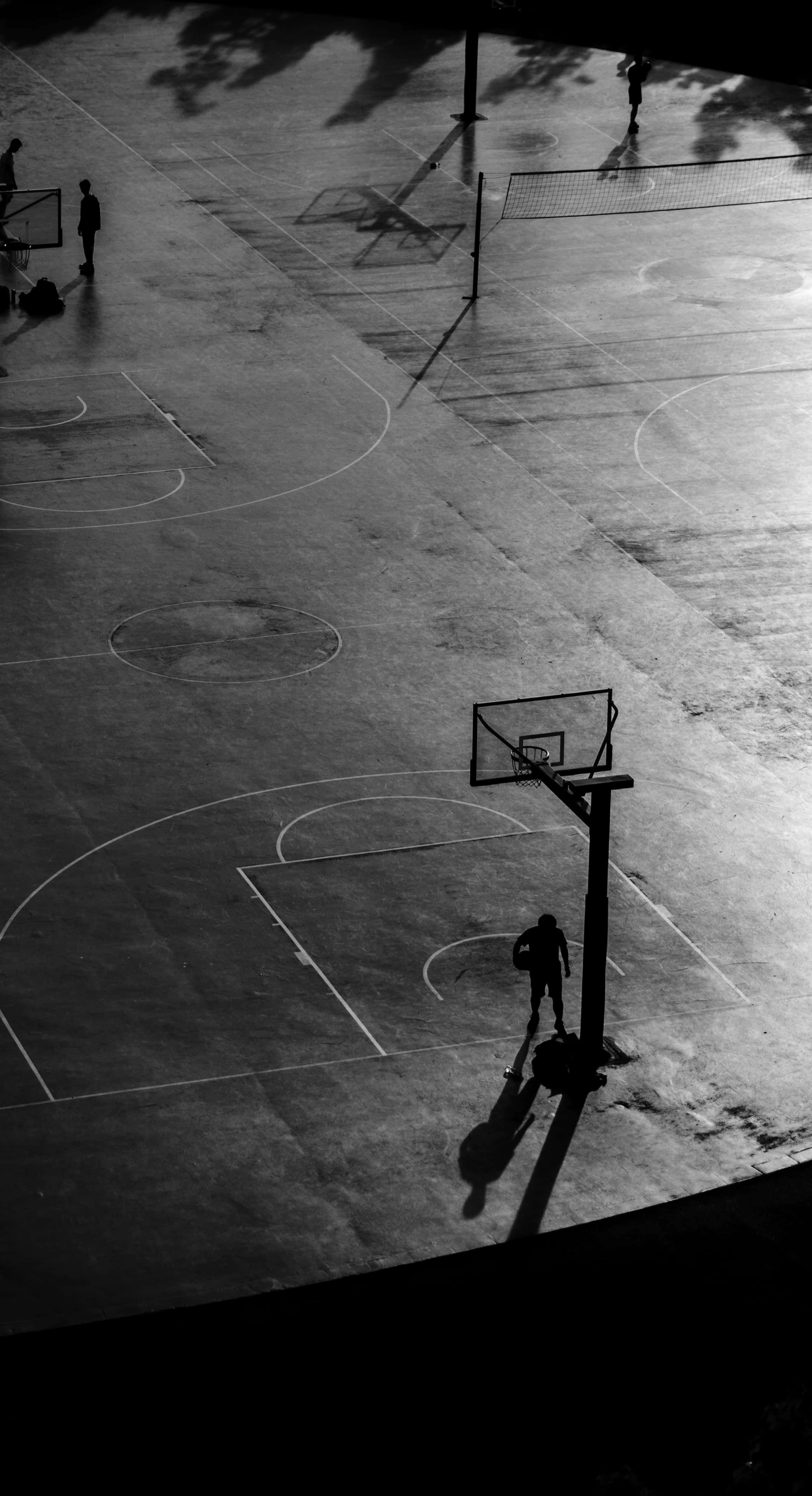 black basketball, outdoor court, silhouetted basketball players, 4K Phone Wallpaper