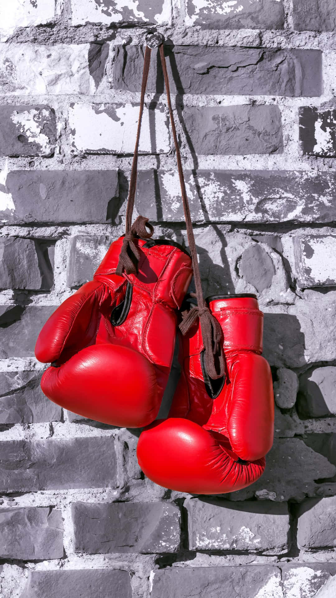 red boxing gloves, worn straps, weathered gray brick wall, Full HD Phone Wallpaper