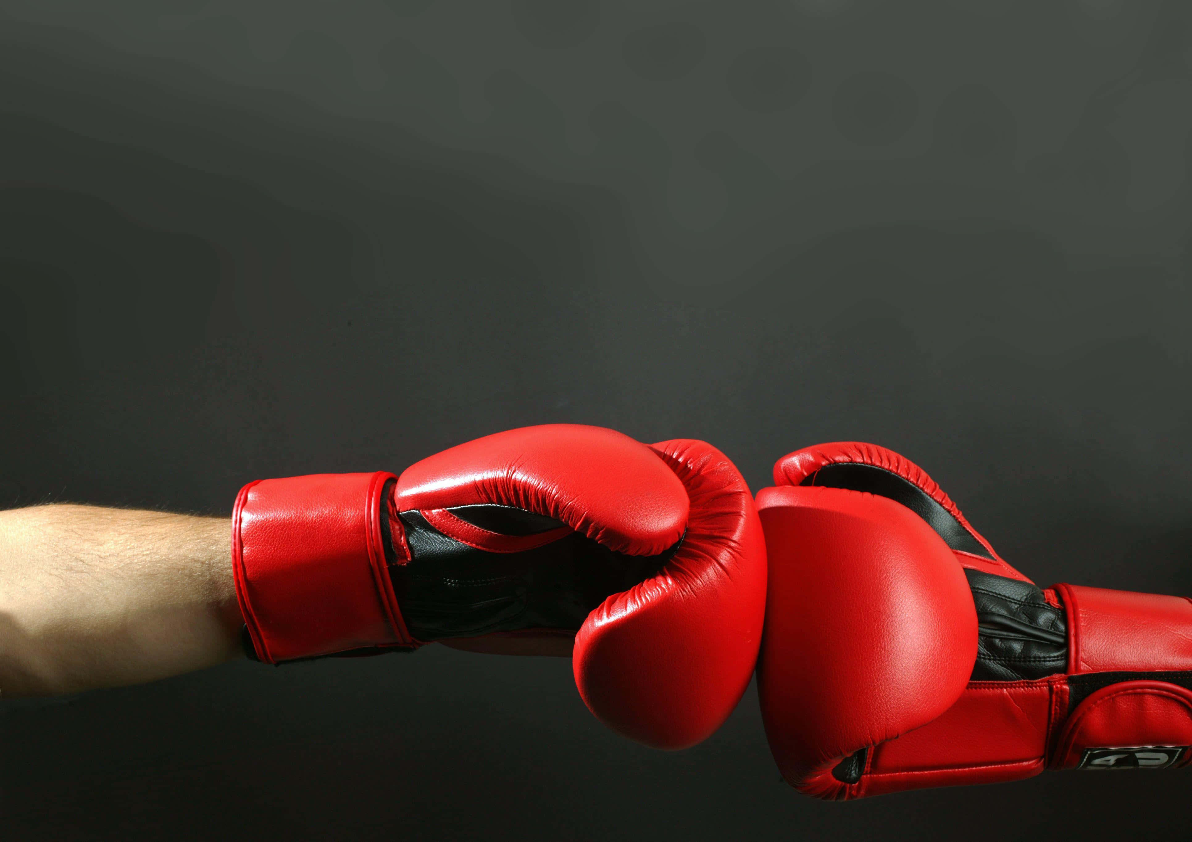 red boxing gloves, dark gray background, firm handshake, 4K Desktop Wallpaper