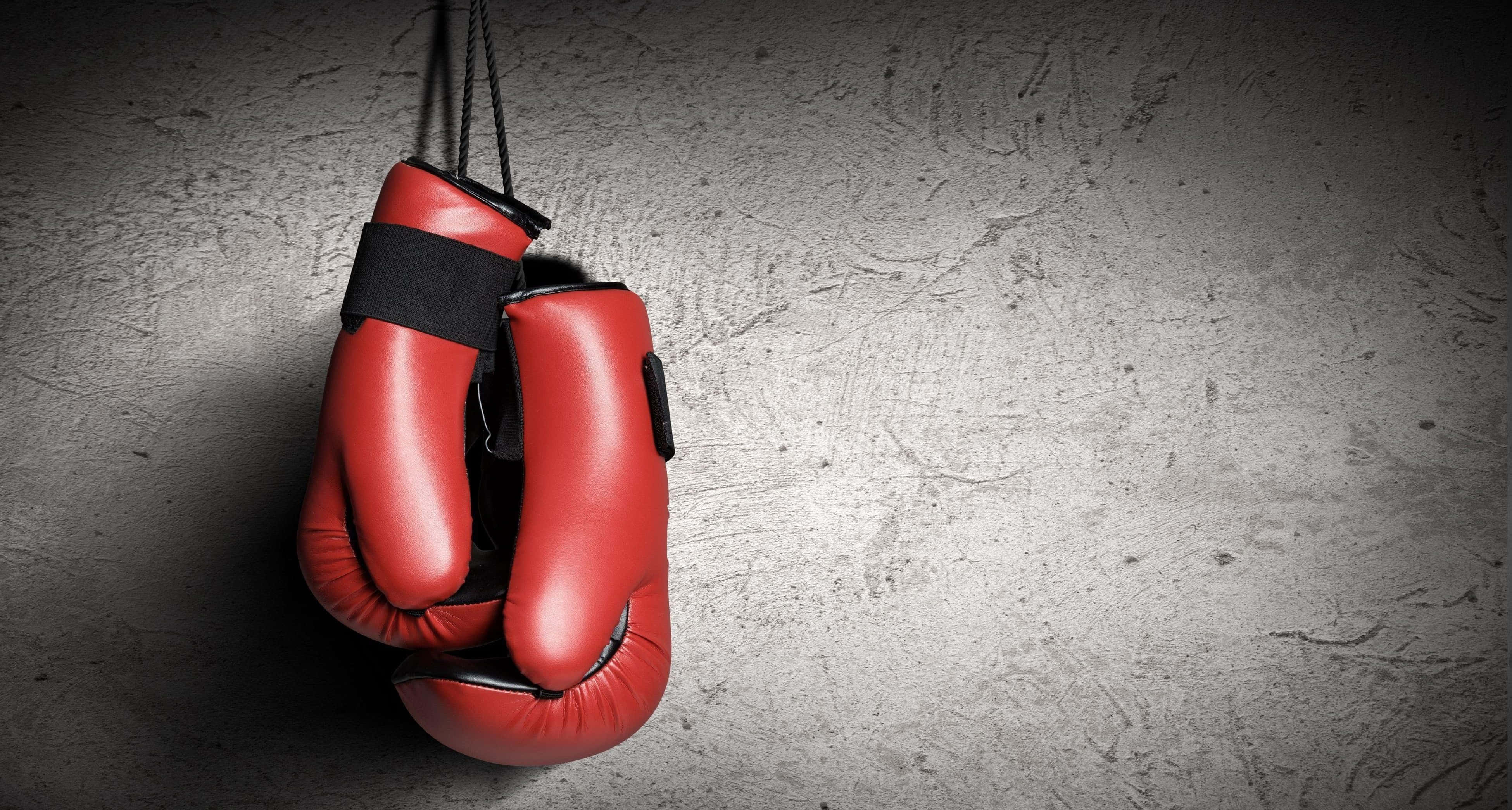 red boxing gloves, black straps, rough gray concrete wall, 4K Desktop Wallpaper
