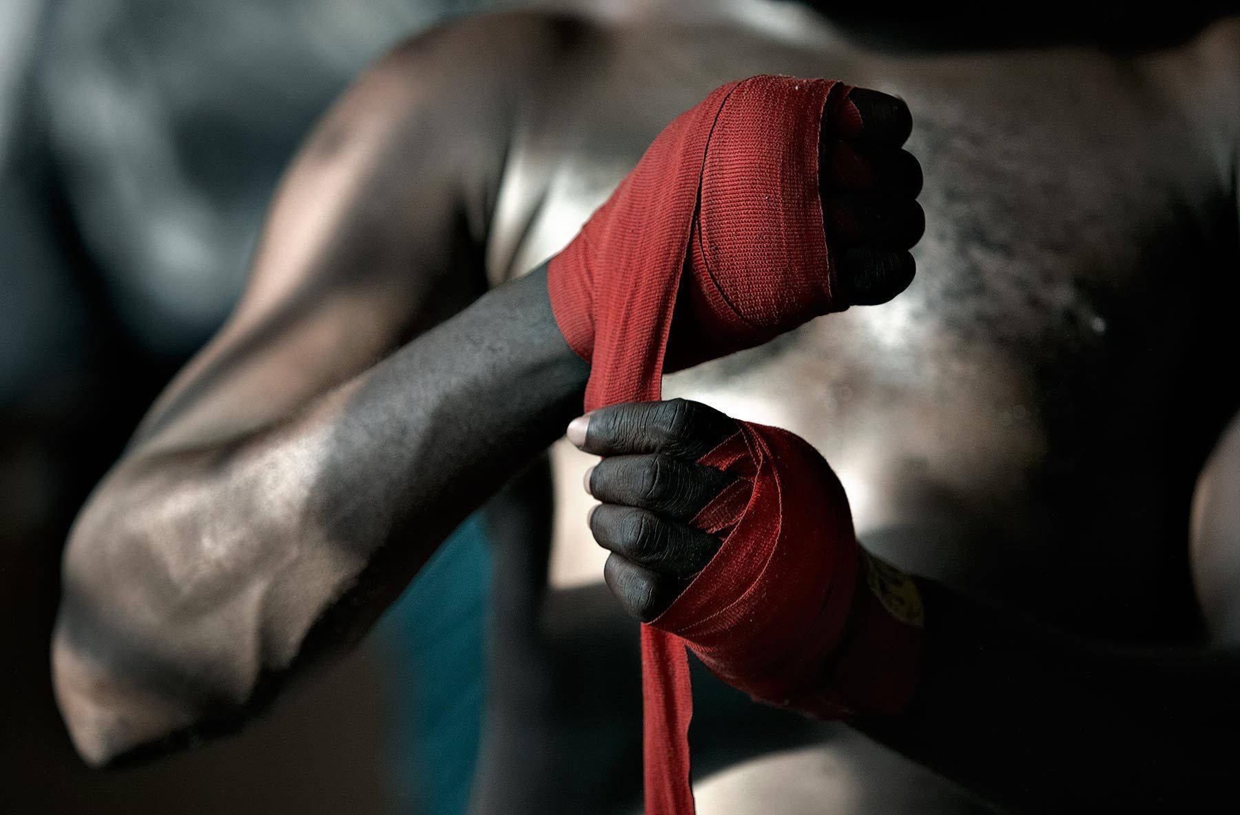 red boxing hand wrap, muscular fighter, dimly lit gym, HD Desktop Wallpaper