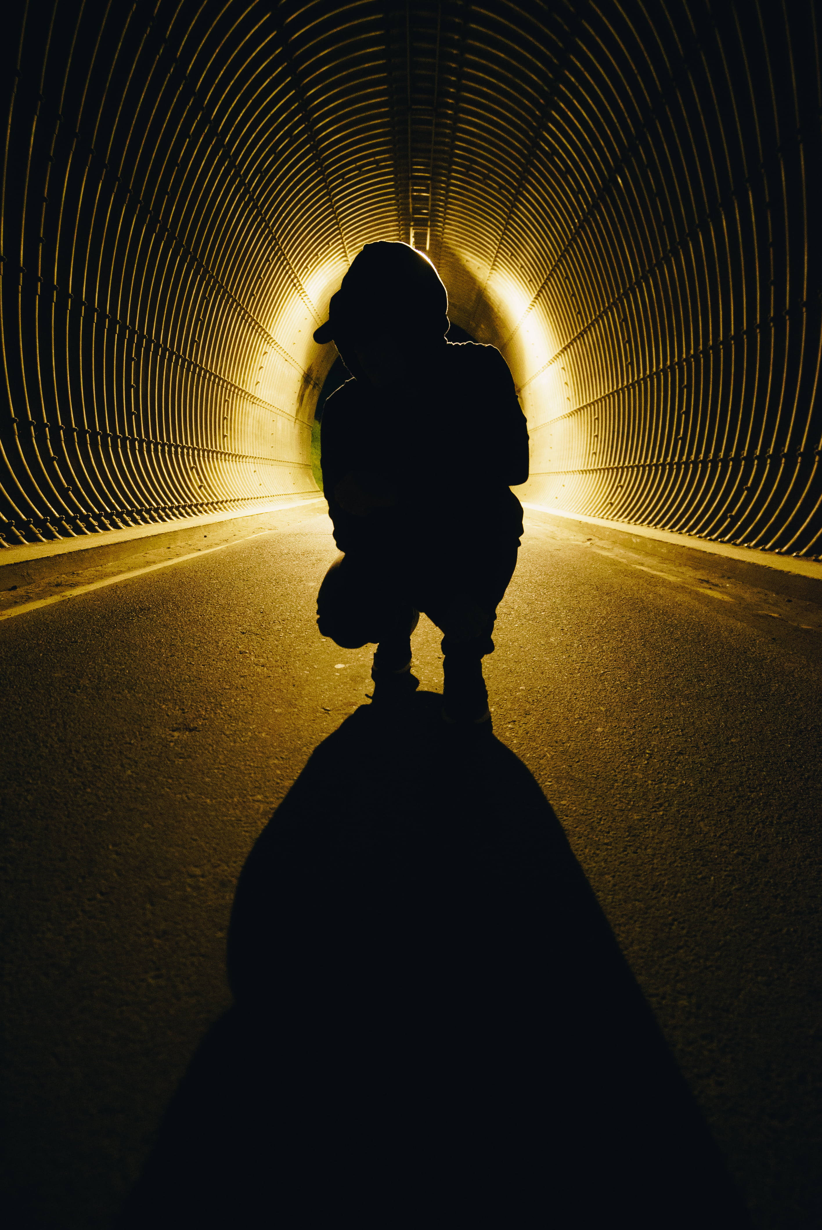 Boy Shadow, dark tunnel, warm golden light, 4K Phone Wallpaper