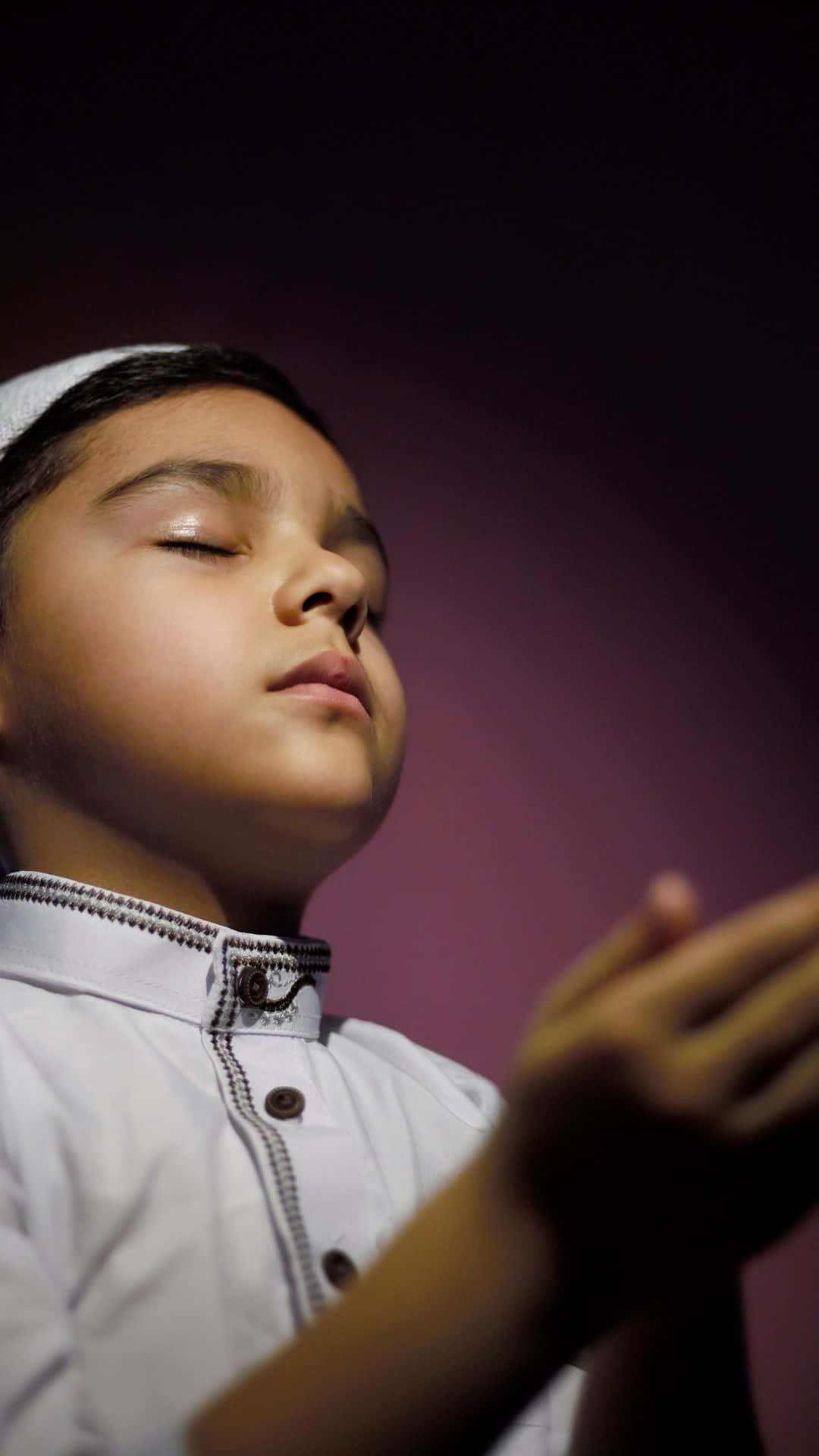 Praying Muslim Boy, traditional white attire, deep purple background, Full HD Phone Wallpaper