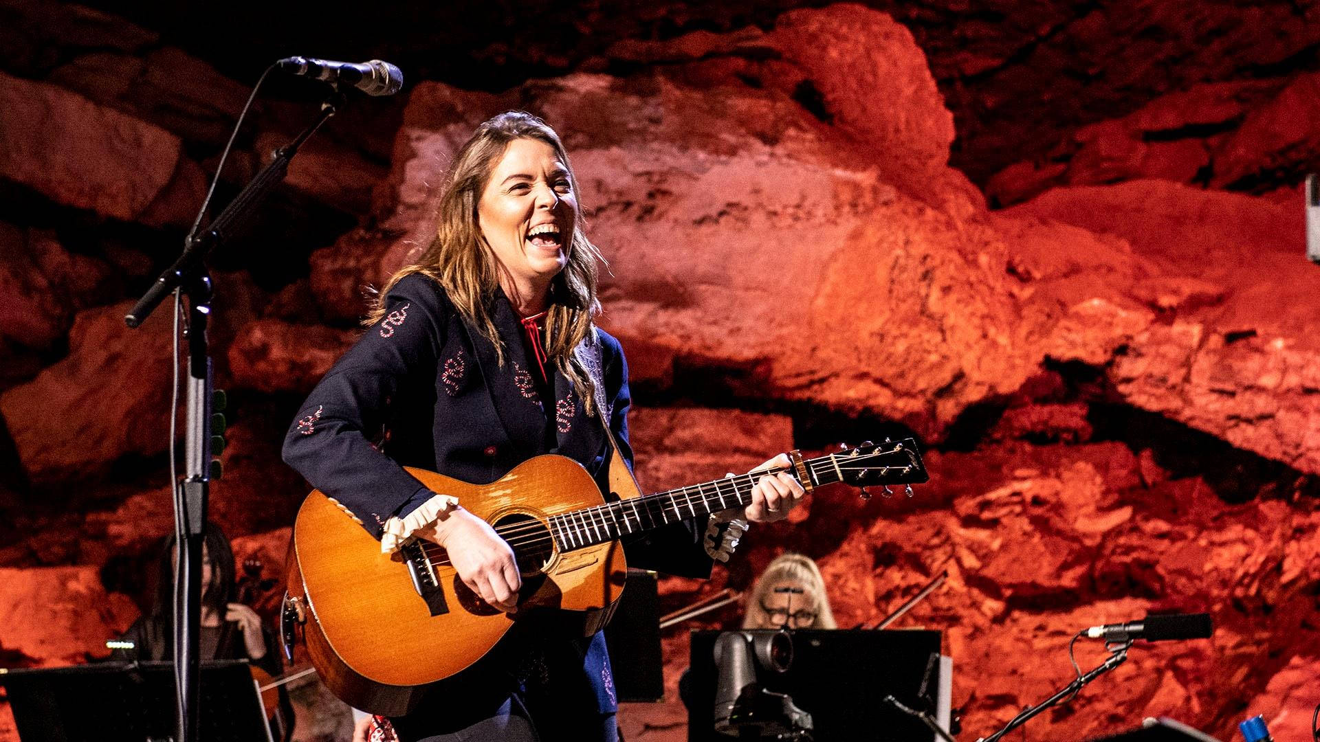 Brandi Carlile, acoustic guitar, warm red lighting, Full HD Desktop Wallpaper