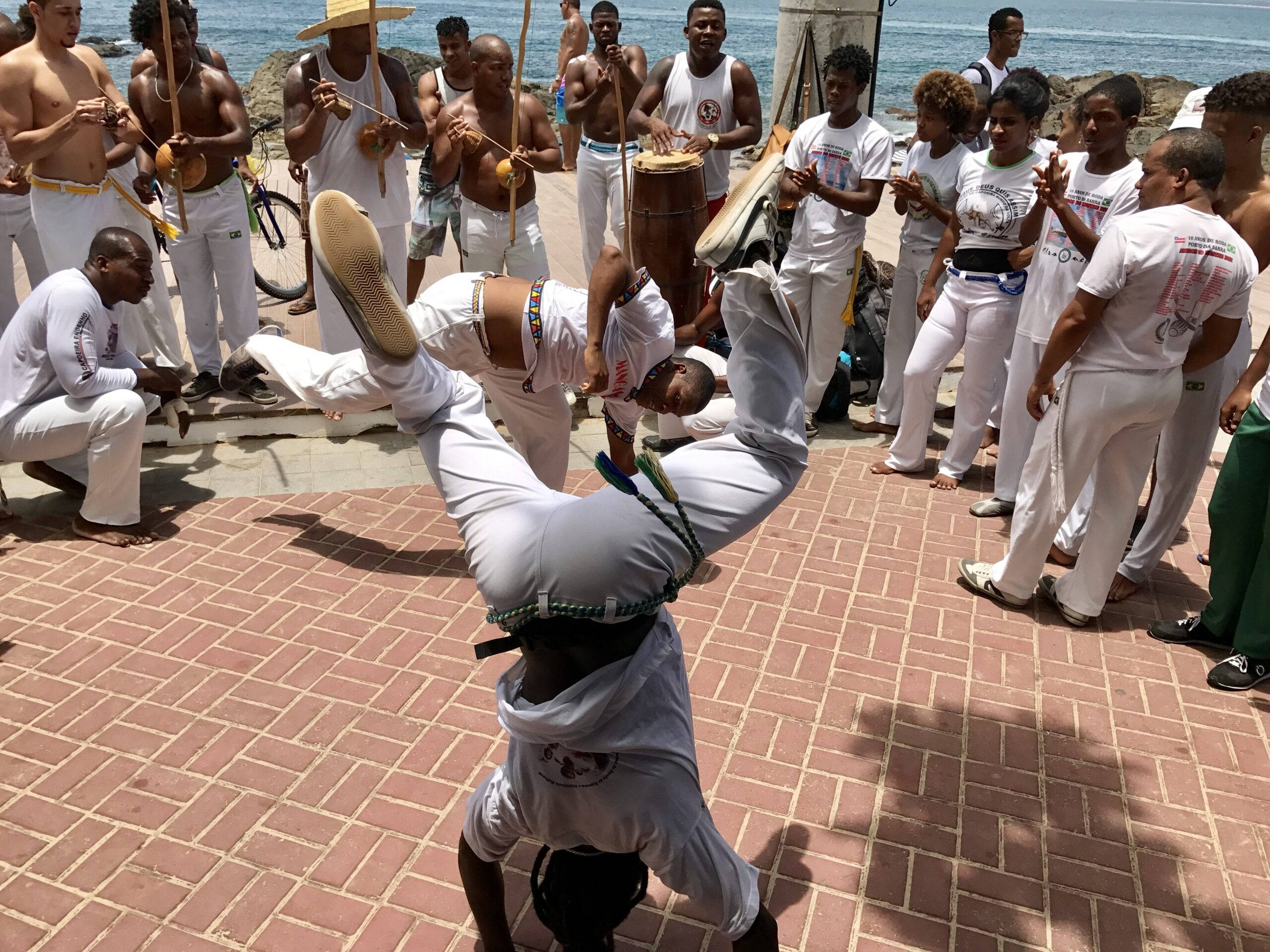 capoeira fighters, sunlit brick plaza, traditional instruments, 2K Desktop Wallpaper