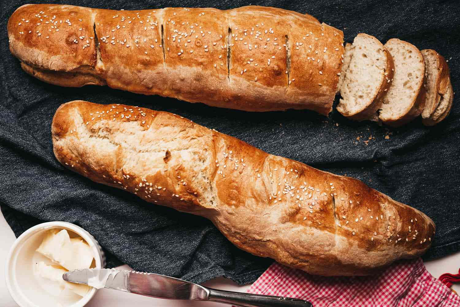 crusty sliced baguette, golden-brown sesame seed baguette, dark cloth, HD Desktop Wallpaper
