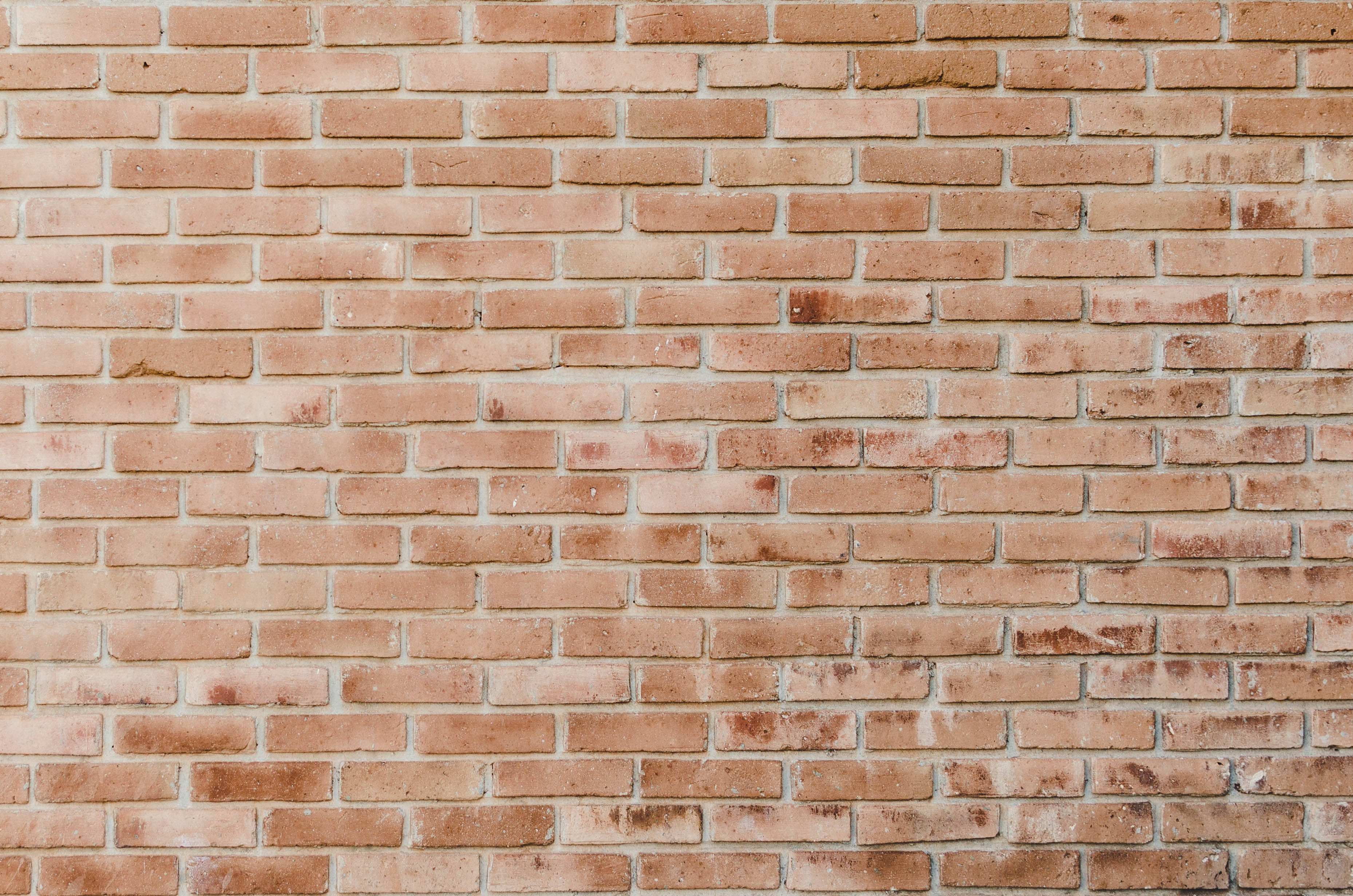nostalgic pale orange brick texture, weathered terracotta bricks, running bond pattern, 2K Desktop Wallpaper