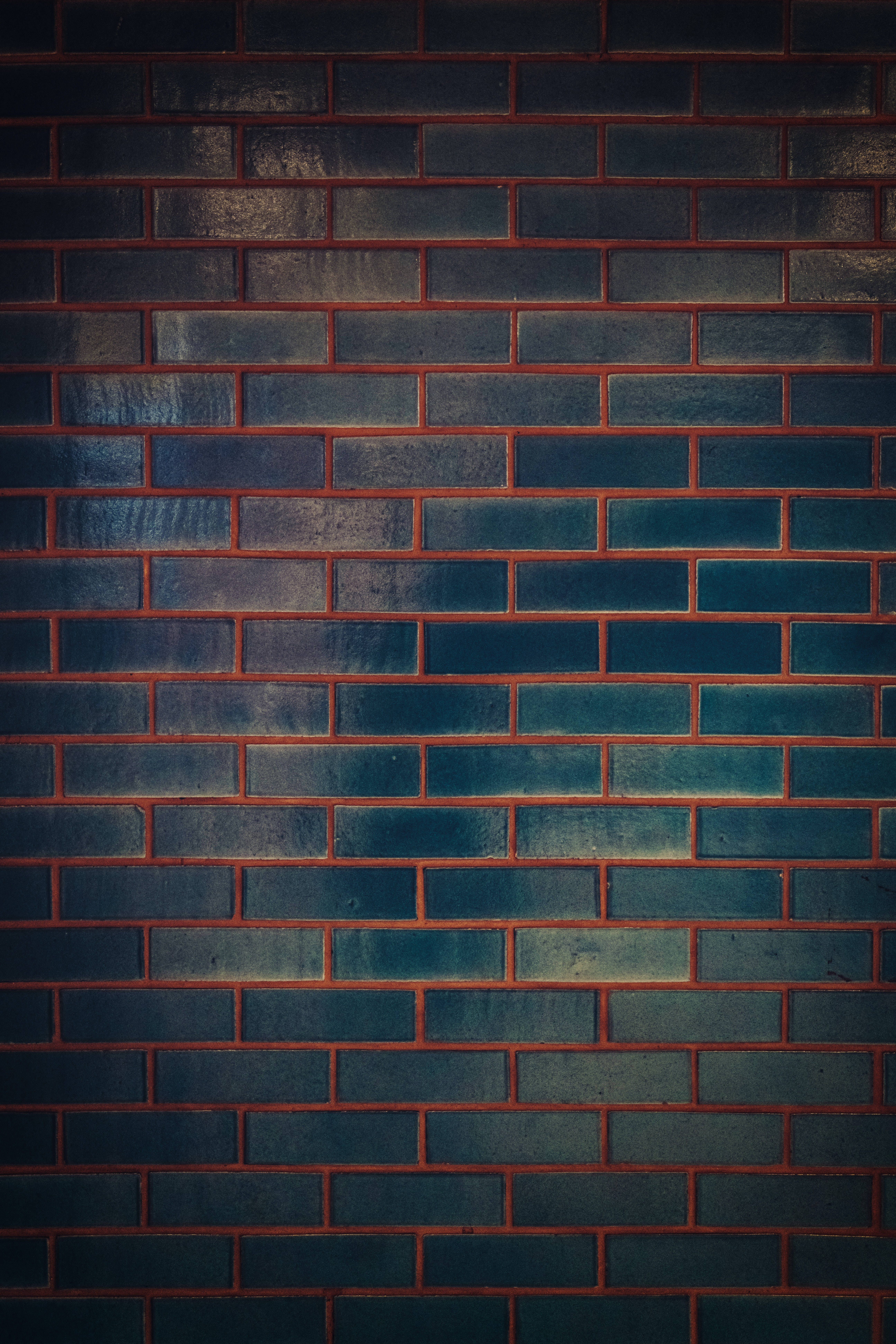 dark brick wall, deep blue bricks, warm red mortar, 8K Phone Wallpaper