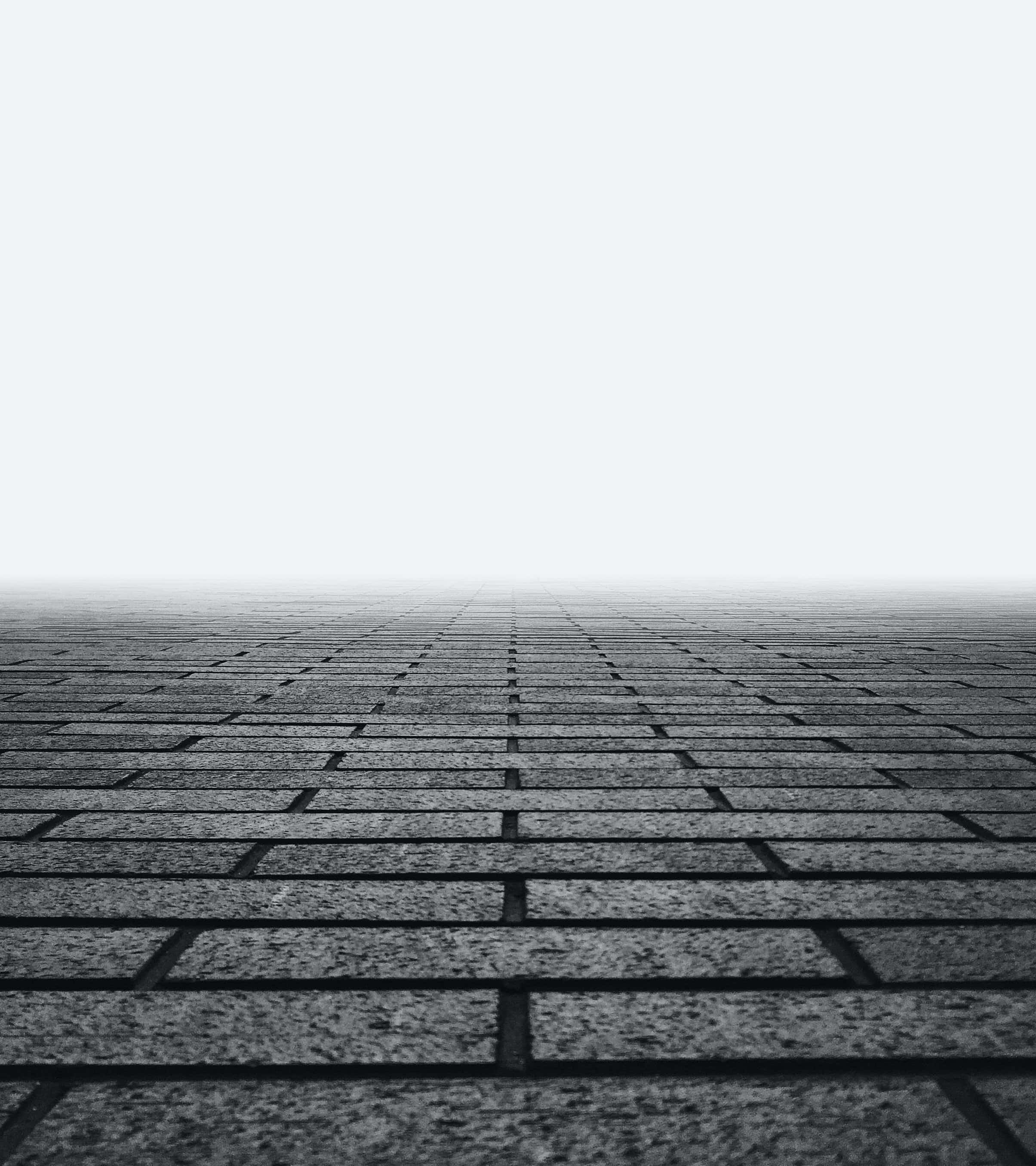 black bricks, stone-paved path, hazy white horizon, 2K Phone Wallpaper