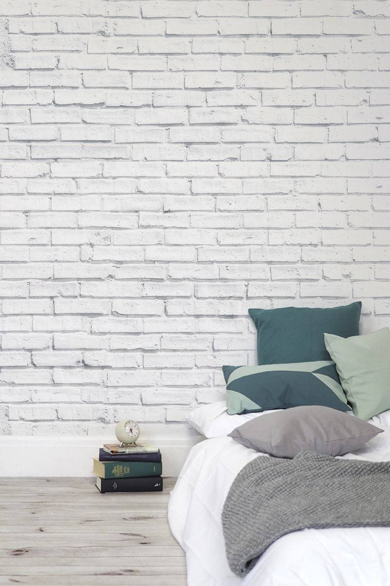 white brick wall, gray wooden floor, green gray and white pillows, SD Phone Wallpaper