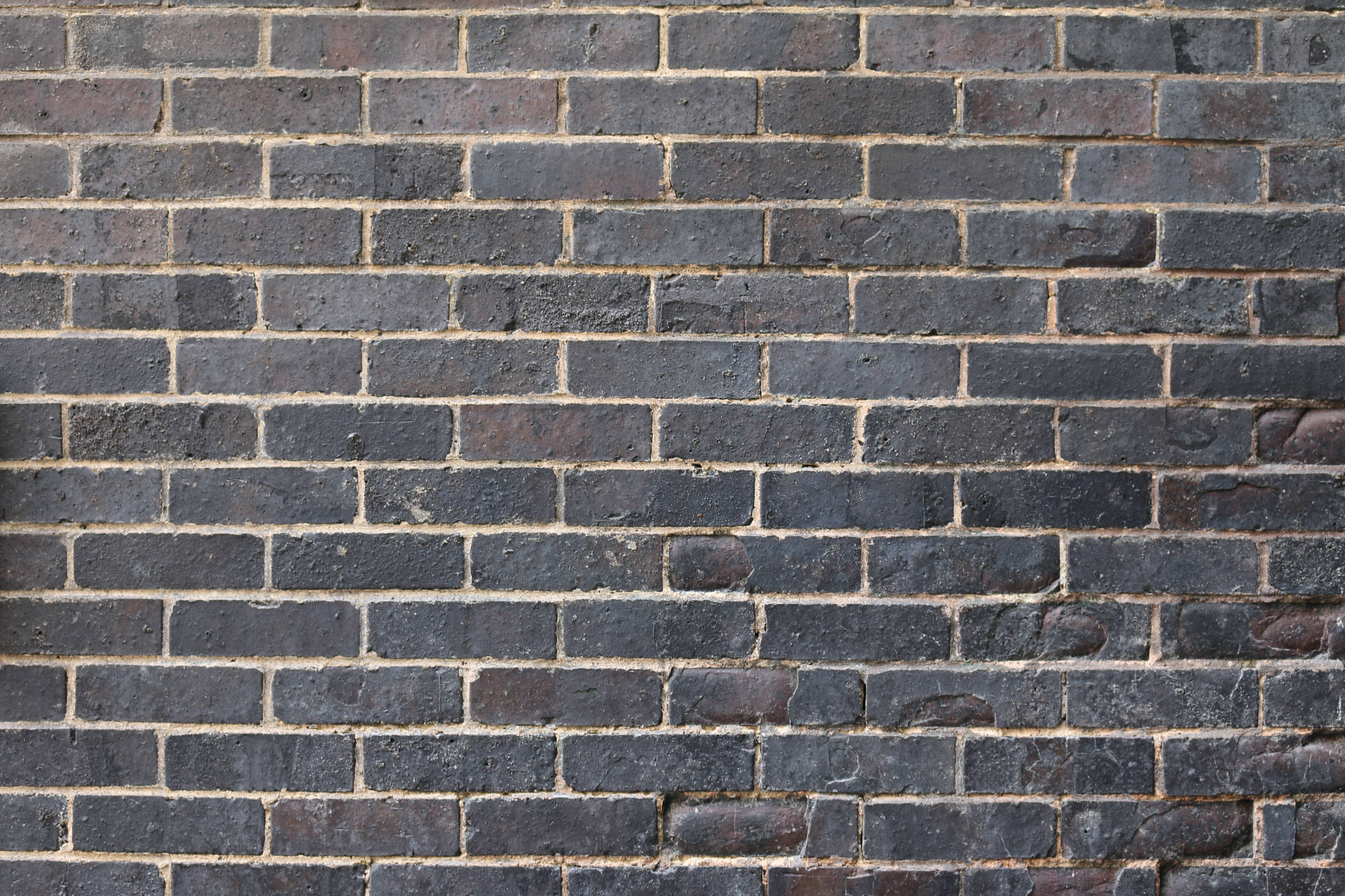 dark gray bricks, light beige mortar, textured urban wall surface, 5K Desktop Wallpaper