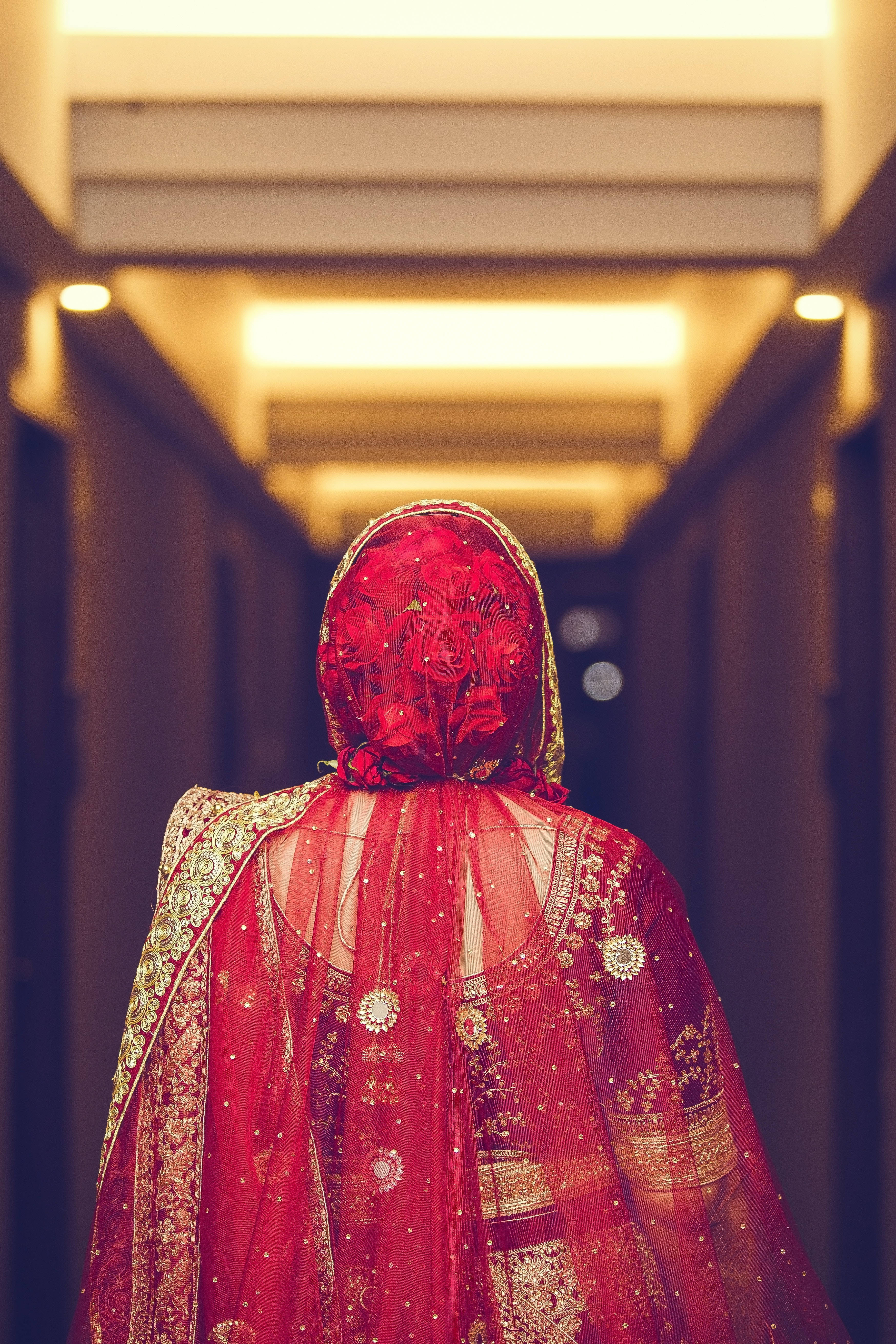 red bridal dupatta, vibrant red embroidered lehenga, hotel corridor, 5K Phone Wallpaper