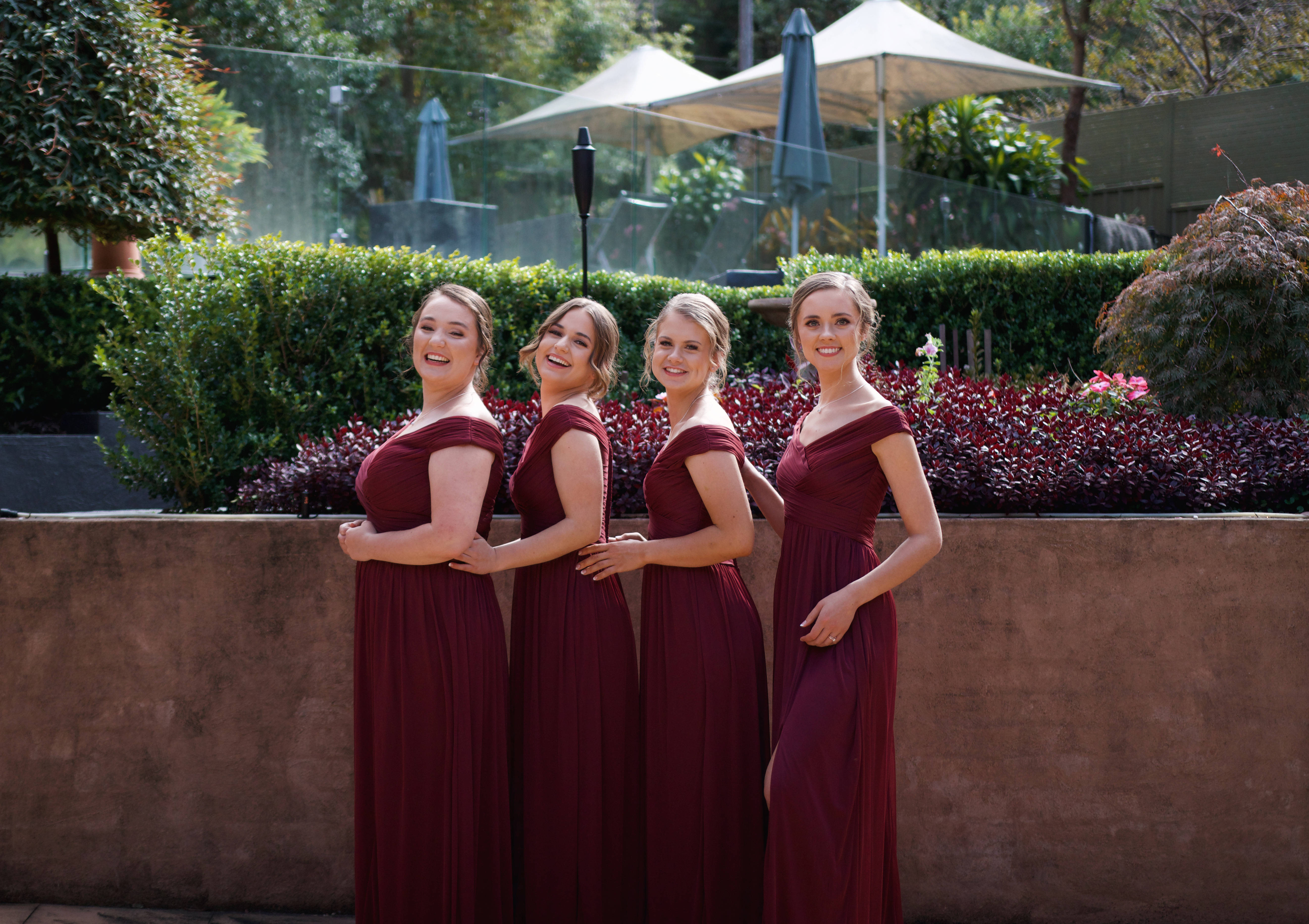 burgundy gowns, lush greenery, patio umbrellas, 5K Desktop Wallpaper
