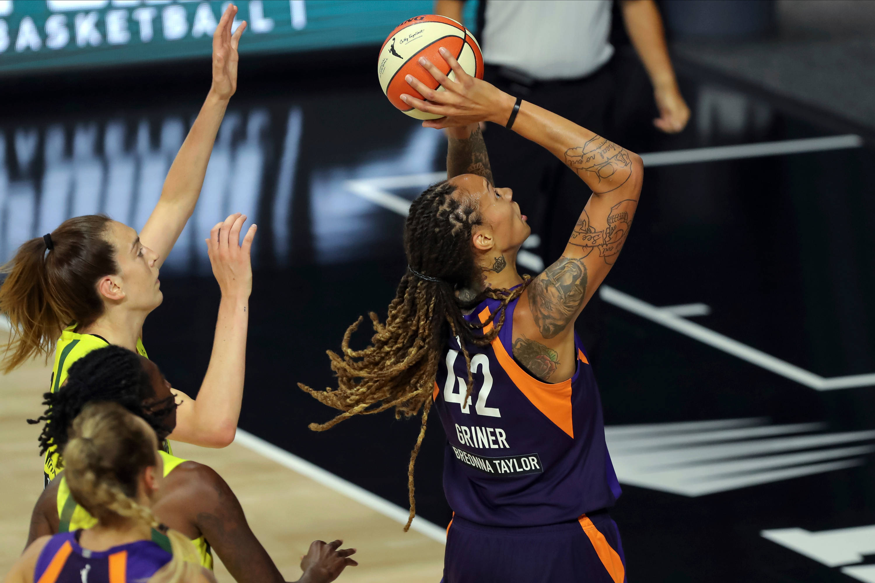 Brittney Griner, purple and orange jersey, leaps to shoot the ball, 2K Desktop Wallpaper