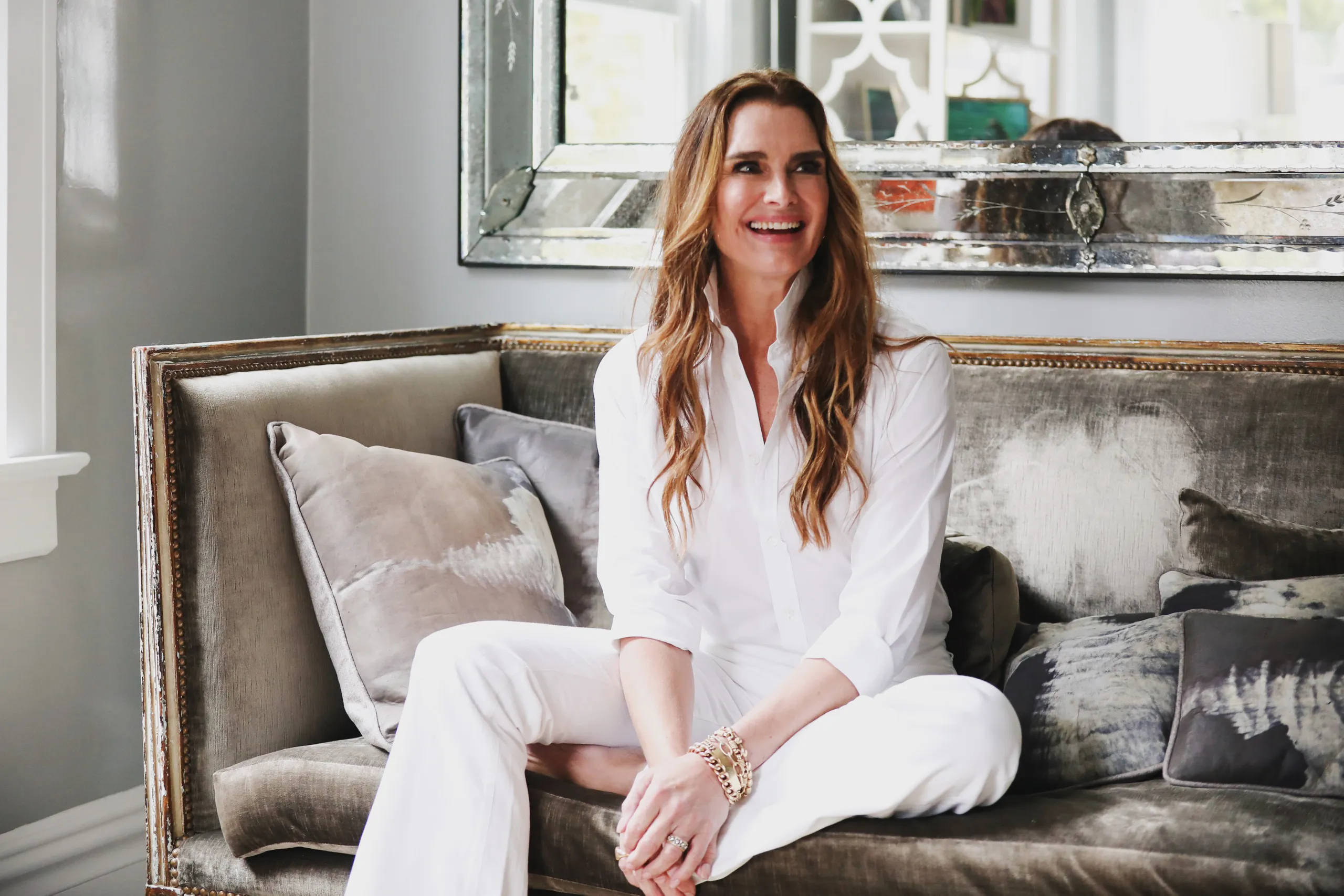 Brooke Shields, white outfit, plush gray velvet sofa, 2K Desktop Wallpaper