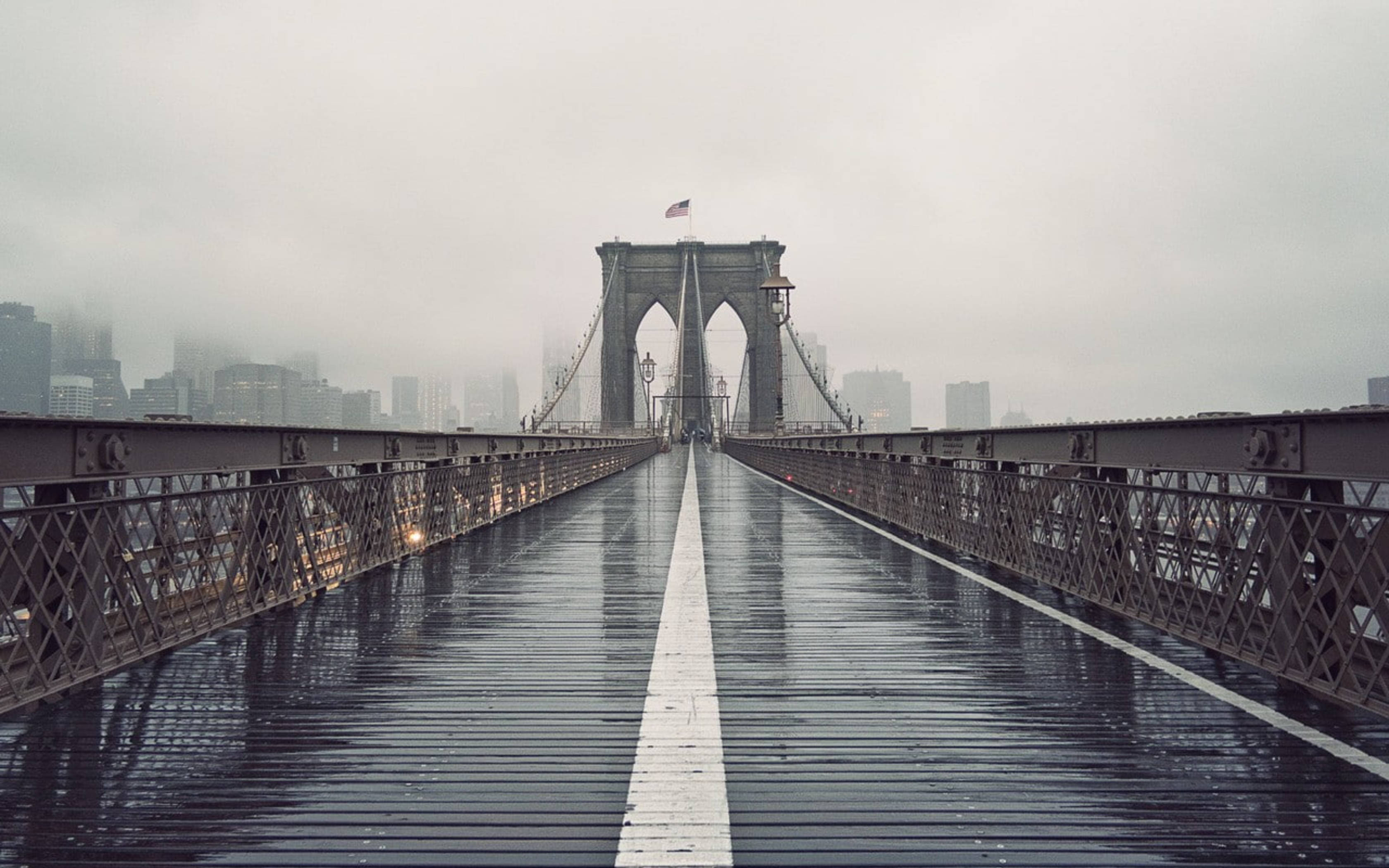Brooklyn Bridge, wet wooden planks, gray skies, 2K Desktop Wallpaper