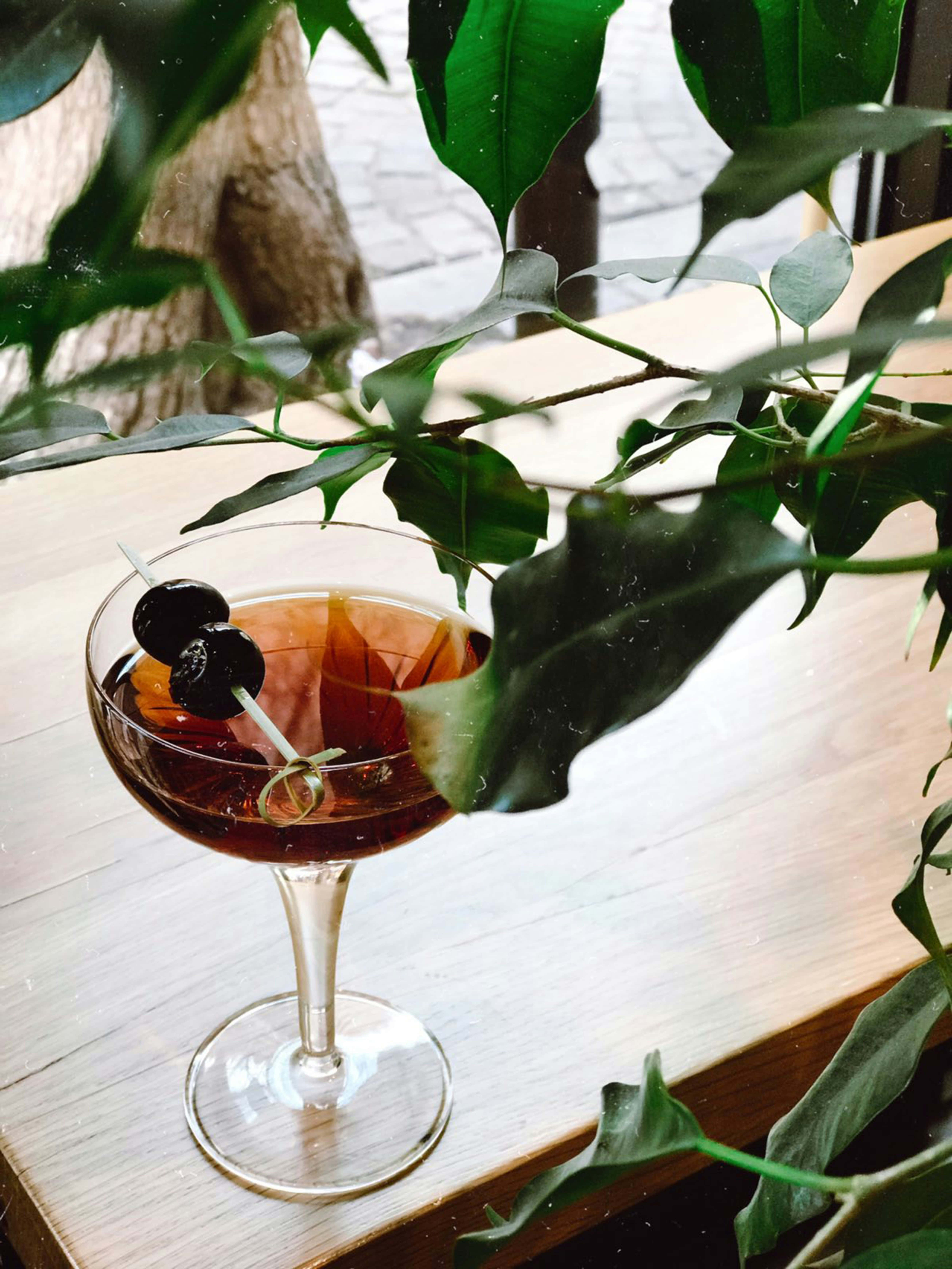 dark amber cocktail, coupe glass, wooden table, 5K Phone Wallpaper