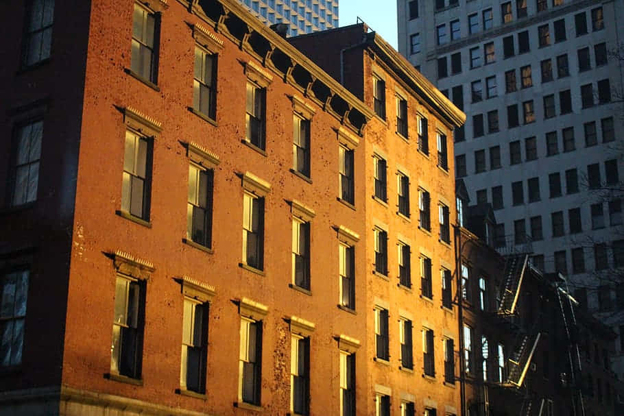 Brownstone Building Exterior, golden hour sunlight, weathered brick apartment building, SD Desktop Wallpaper